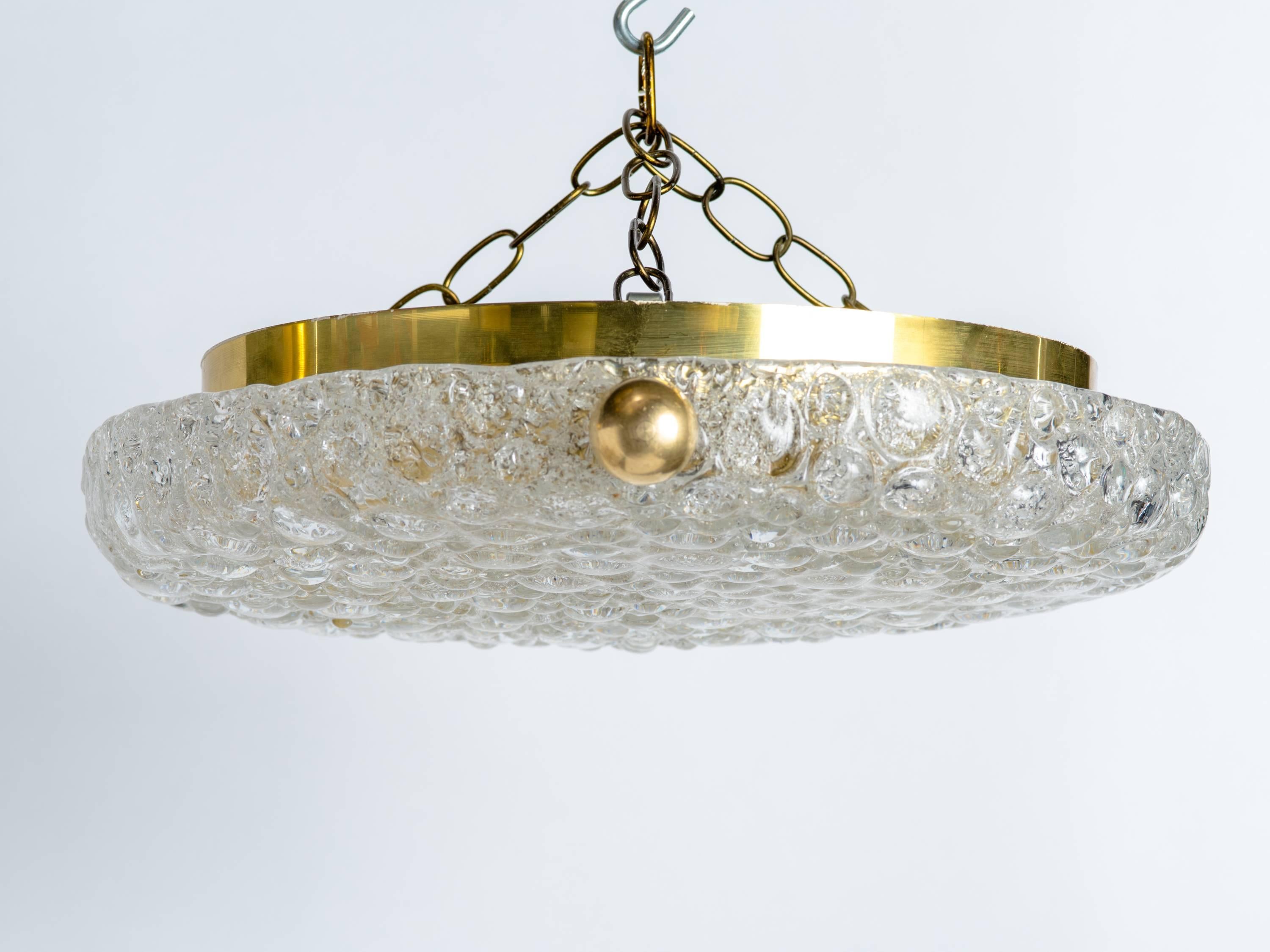 Gorgeous ceiling light comprised of handblown glass with bubble design and texture. The fixture has a circular brass frame with large glass dome, and large brass ball finials. Conveniently fitted with four lights.