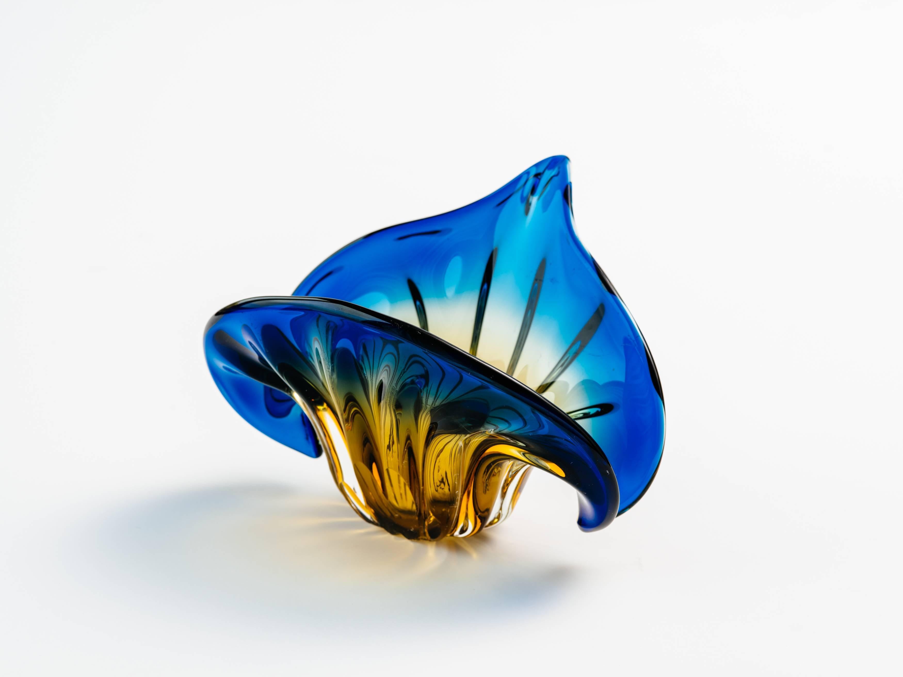 French Art Deco bowl or vase comprised of handblown Murano glass in gradient colors of marigold yellow, amber, and royal blue. The vase has a fleur-de-lis or flower of the lily design. It features fluted accents with winged sides and tapered tip