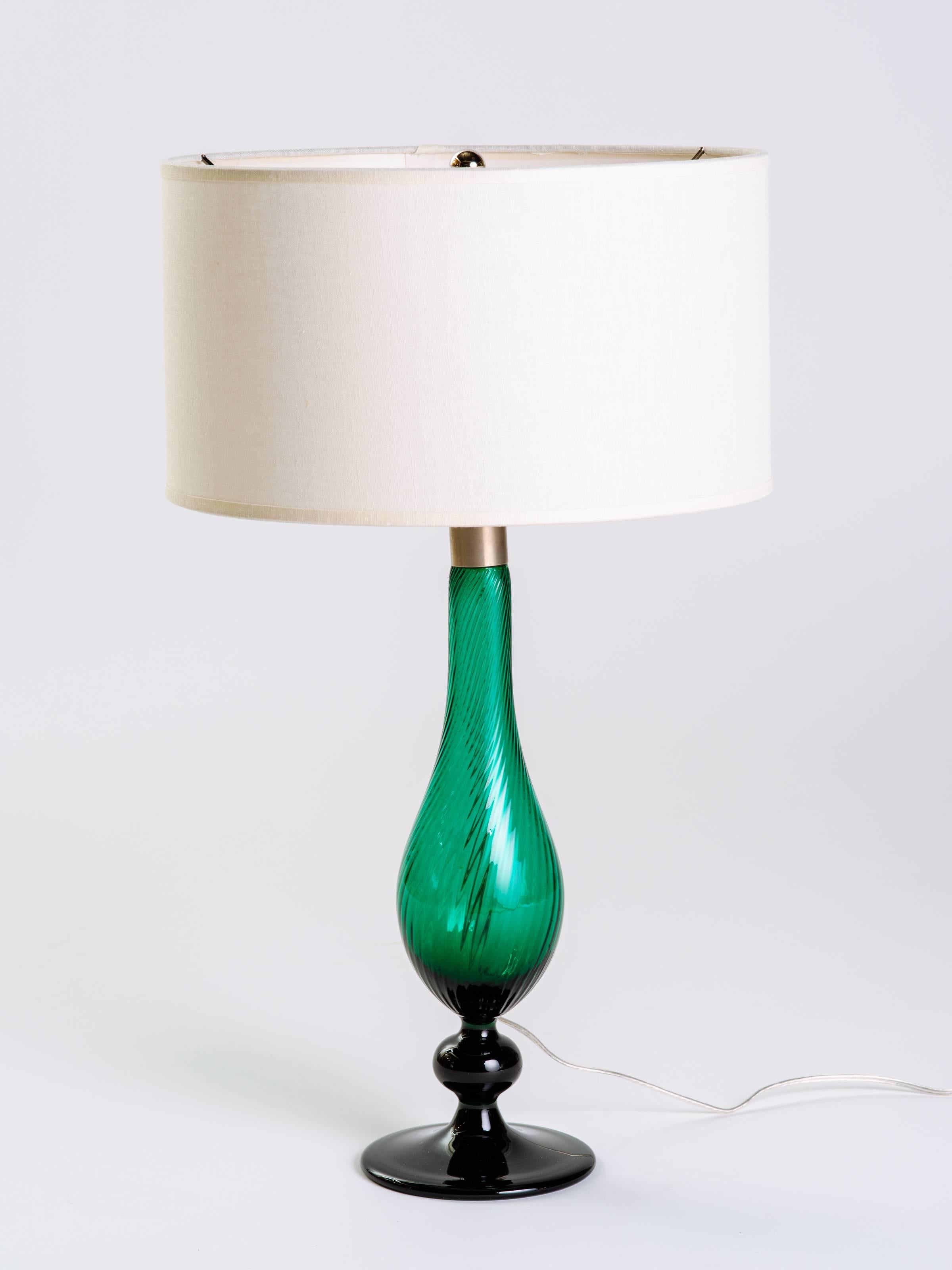 Stunning pair of handblown emerald green glass lamps from the Venice series, by Royal Copenhagen. Lamps have elegant baluster forms with footed bases and feature fluted details. Brushed nickel fittings and sockets, and newly rewired. Shown with