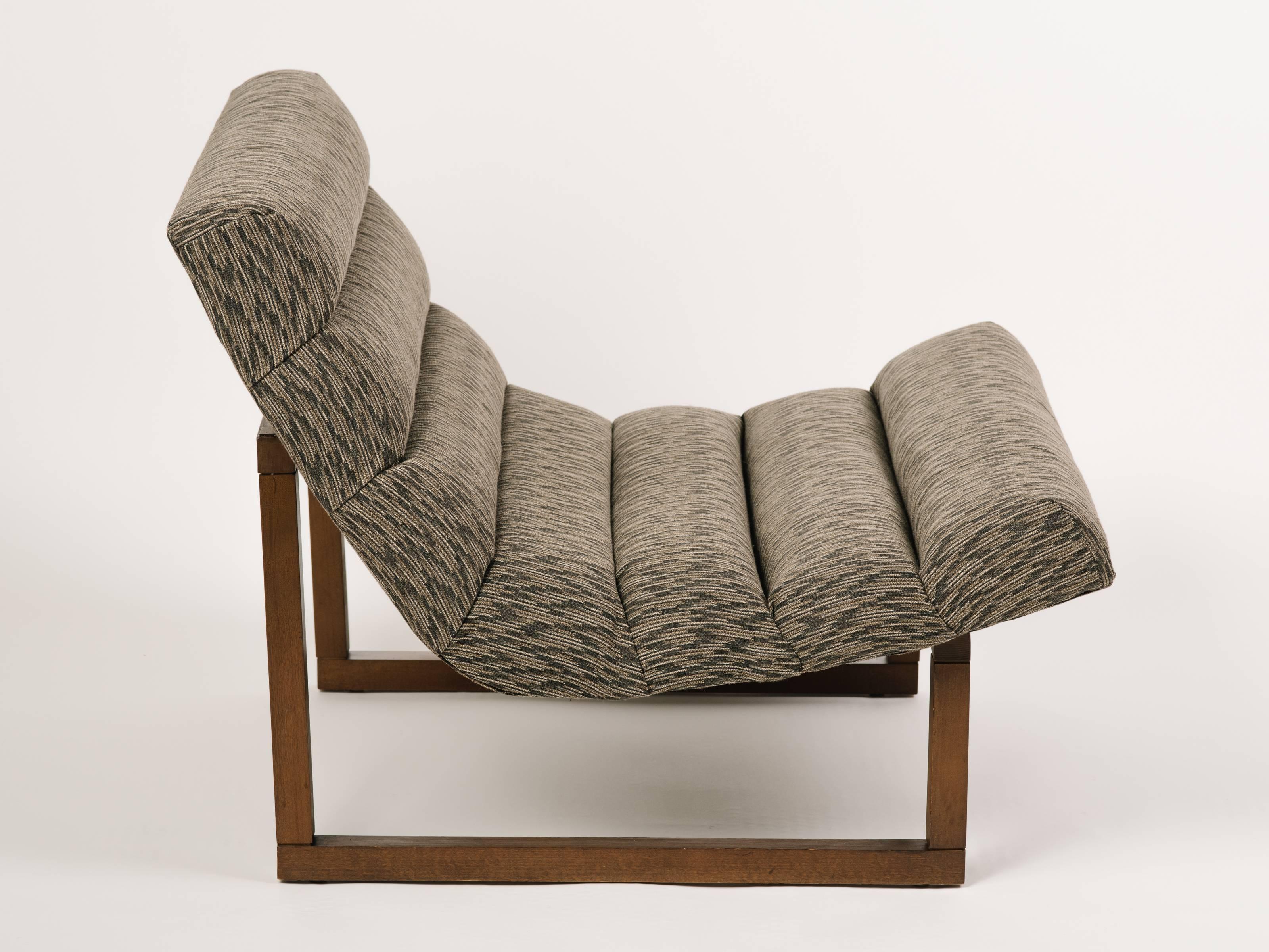 Mid-Century Modern lounge chairs with floating scoop seats and streamline walnut wood frames. Great looking from all angles, and featuring horizontal channel tufting. Upholstered in woven cotton blend fabric with geometric print in hues of taupe,