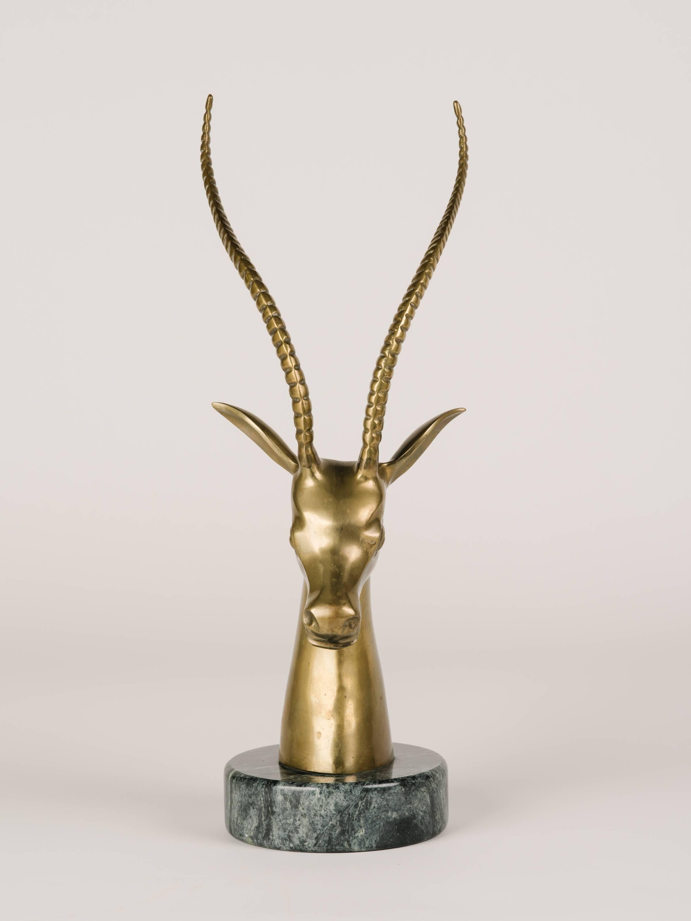 Midcentury hand-forged sculpture of stylized gazelle or ibex. Minor patinated spots on brass adds to its vintage beauty. Features a hand polished exotic marble base in hues of black and grey.
