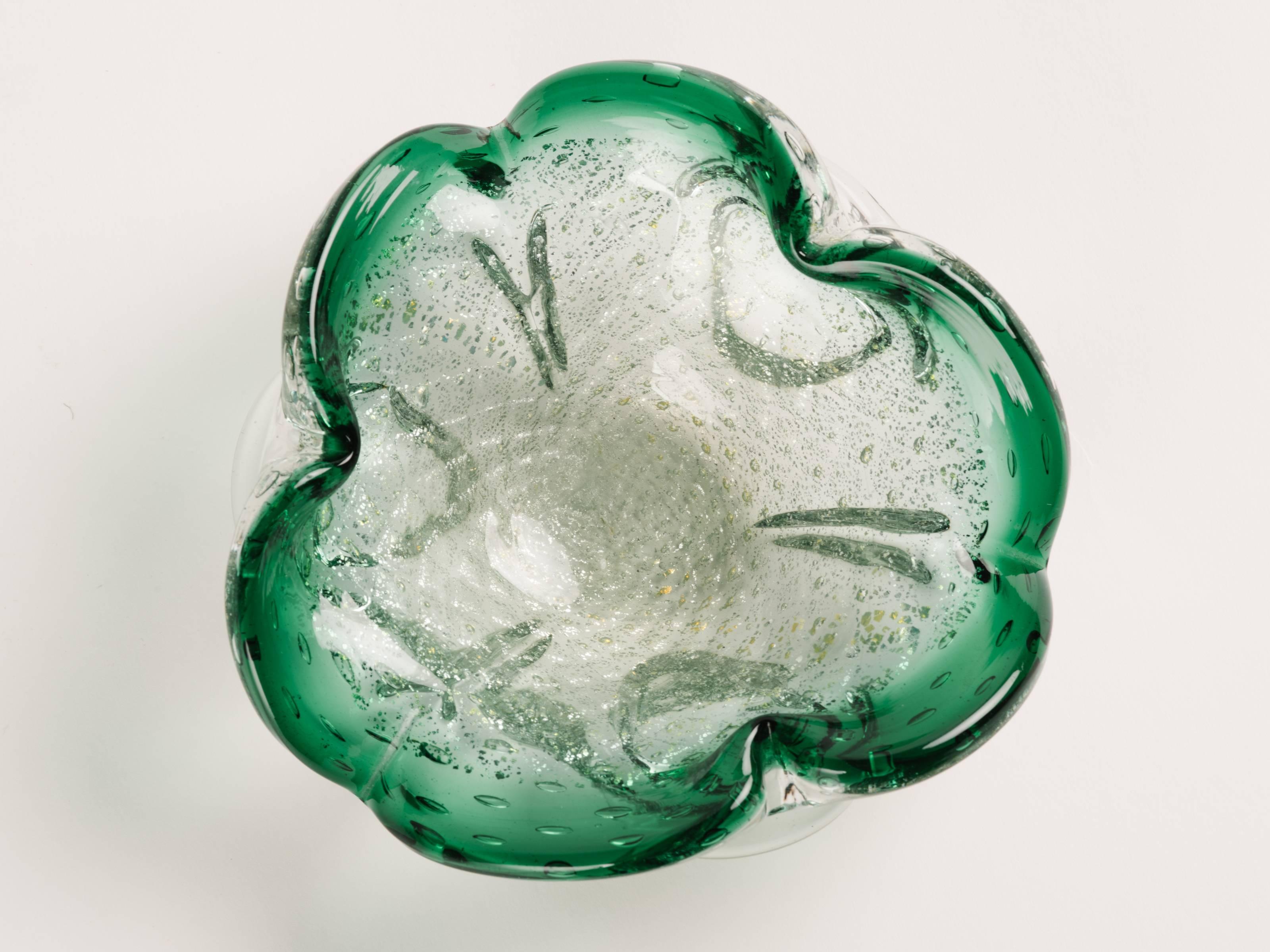 Mid-Century Modern Murano glass bowl or ashtray with organic form. Handblown process with bubble glass design in hues of emerald green with gold flecks accents. Features pinched rims with flared sides.