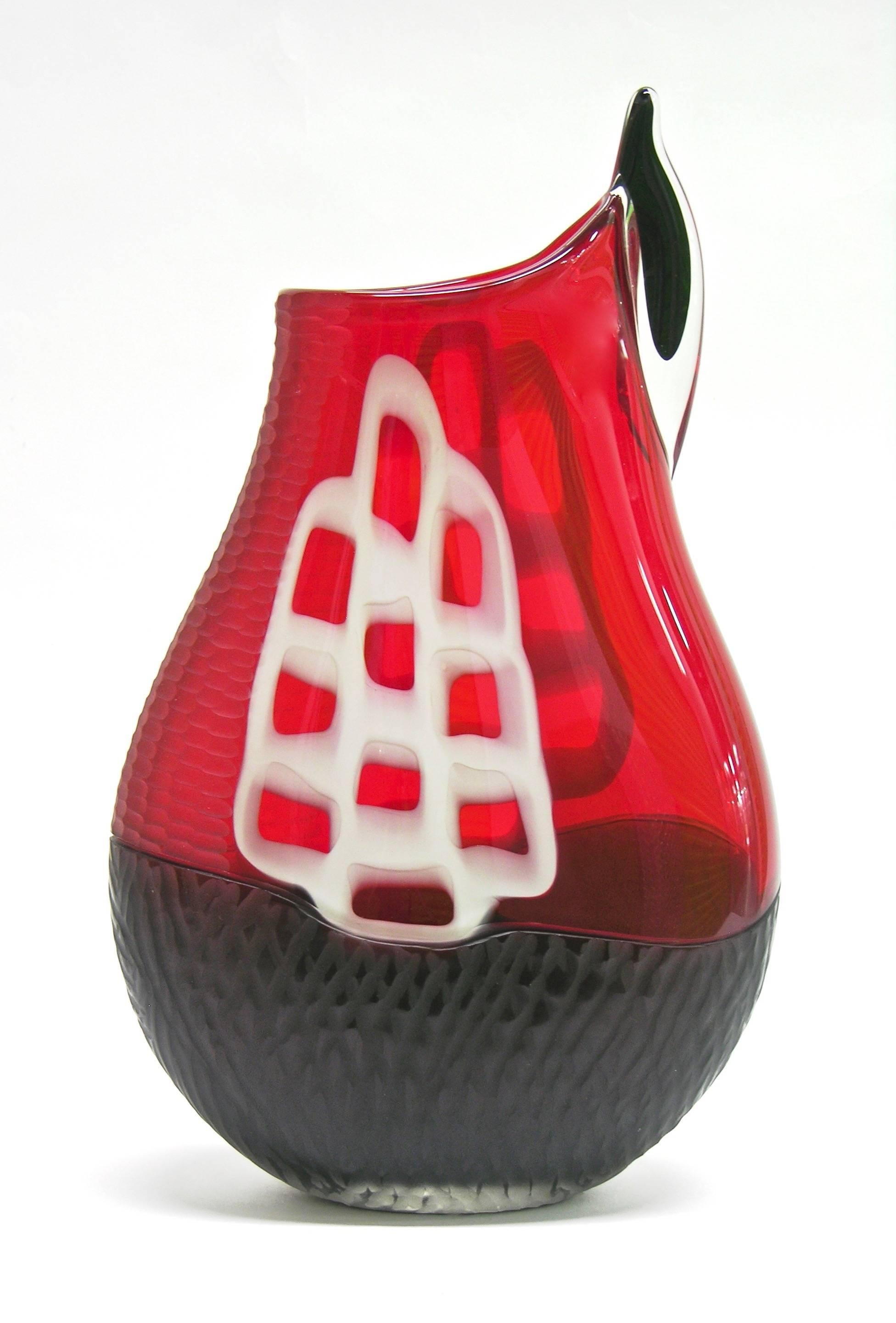 Sculptural Work of Art in blown Murano glass signed by Alberto Dona, a sophisticated overlaid piece worked with the incalmo technique, the black glass bottom part topped with a red upper part decorated with white geometrical Murrine. This piece is