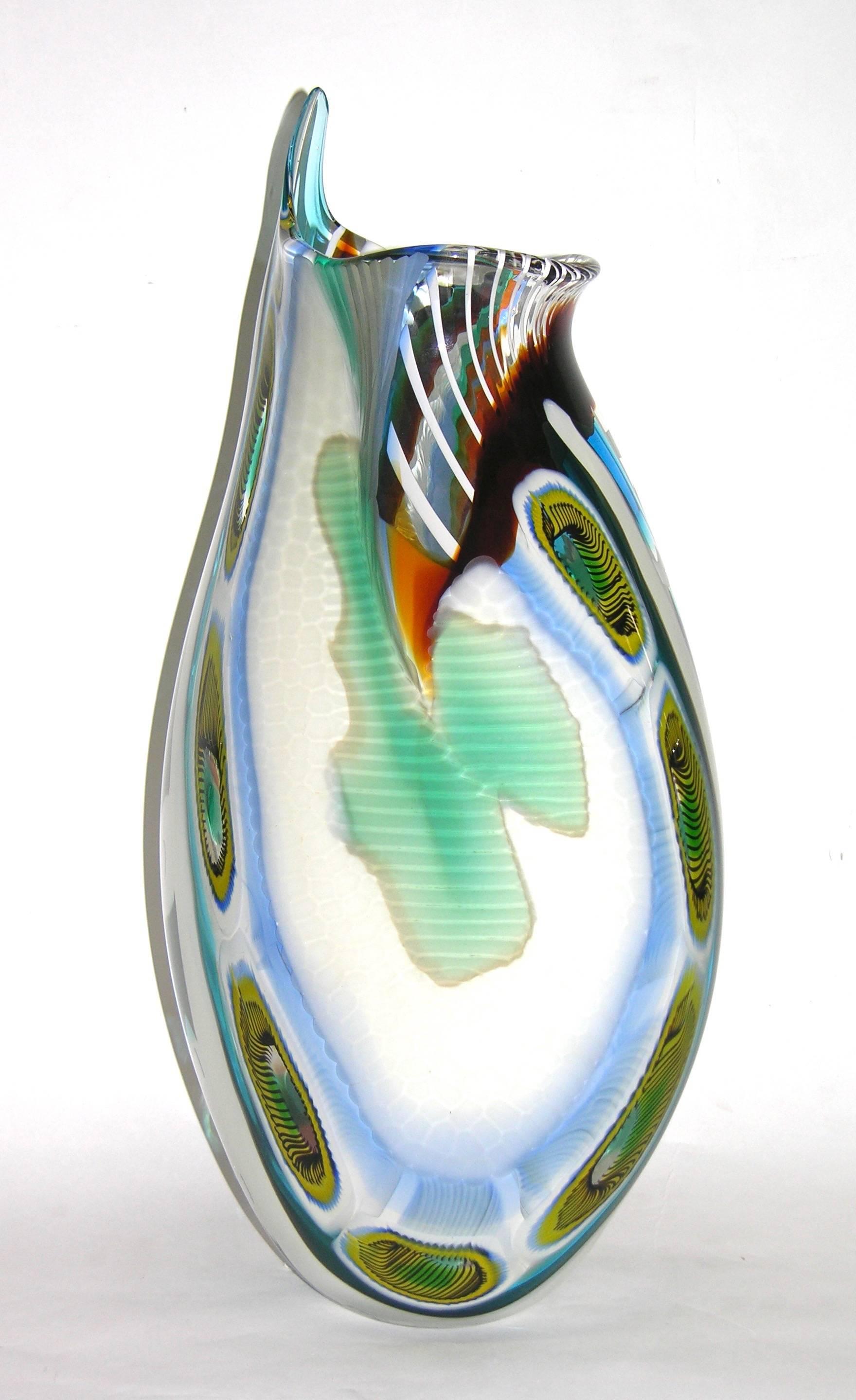 This unique blown vase in Murano glass shows an exceptional work not just for the fabulous colored murrine and the several area decorated with different “battuto” but also for the unique design of rectangular murrine that gives the effect of a