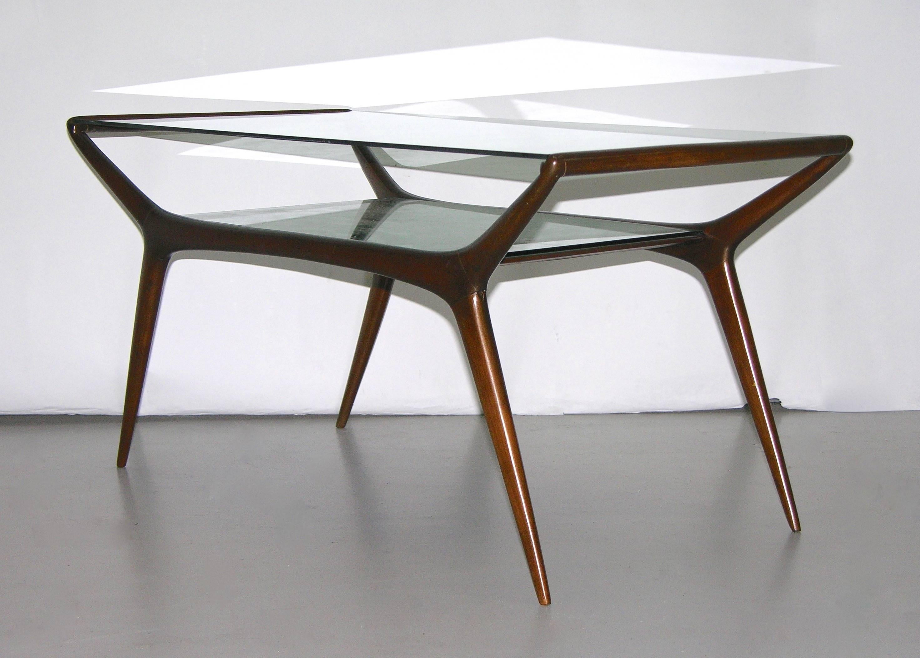 A rare design by Ico Parisi, a sophisticated low table of sleek modern lines, the embracing mahogany structure has a practical under-tier with glass matching the top surface that is glass with a very elegant blue green tint.
 