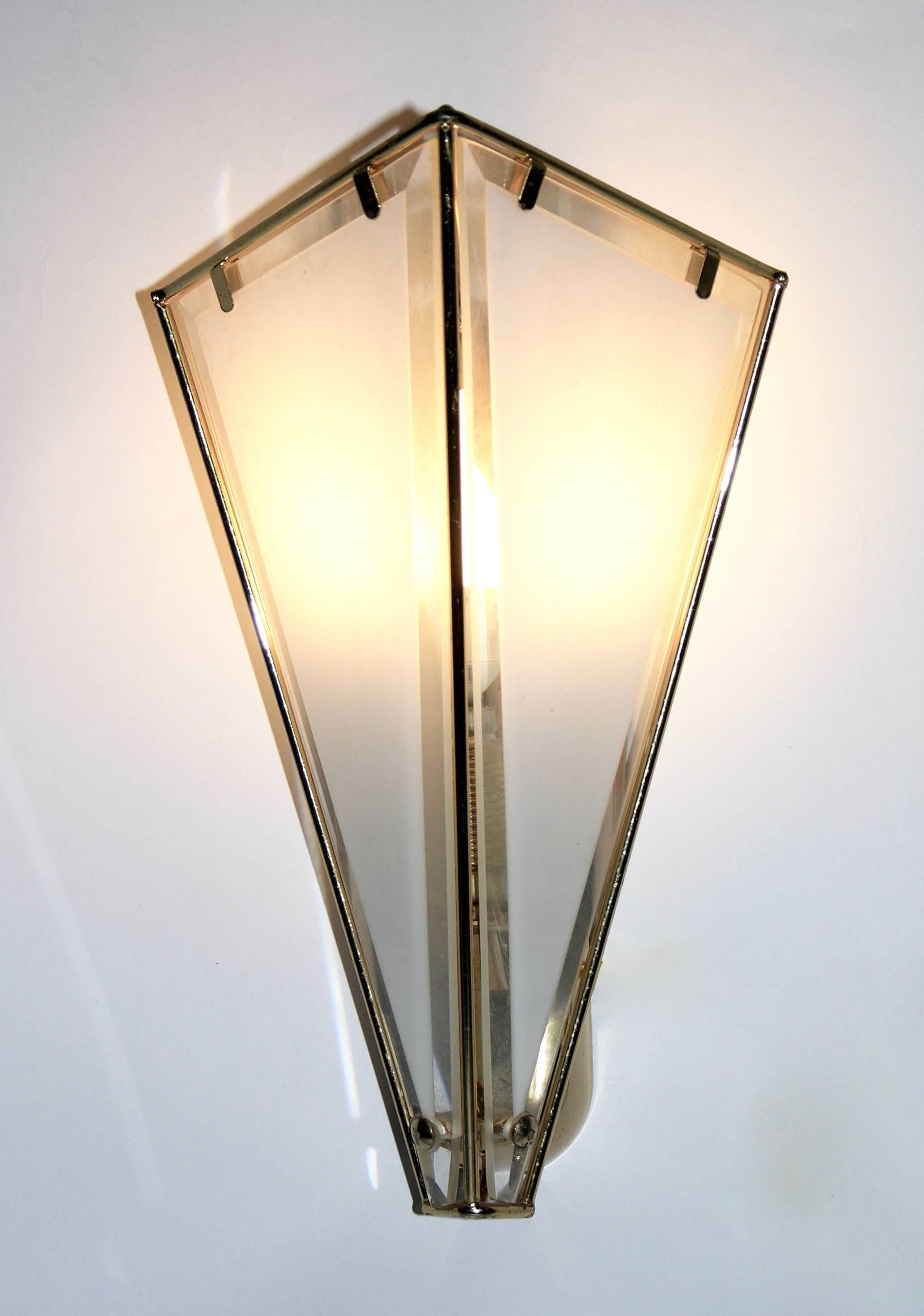 A charming pair of Italian sconces by Metalarte, the unusual triangular shape giving elegance with clean lines, quality of execution with hand made brass structure decorated with white frosted glass panels highlighted with elaborate clear beveled
