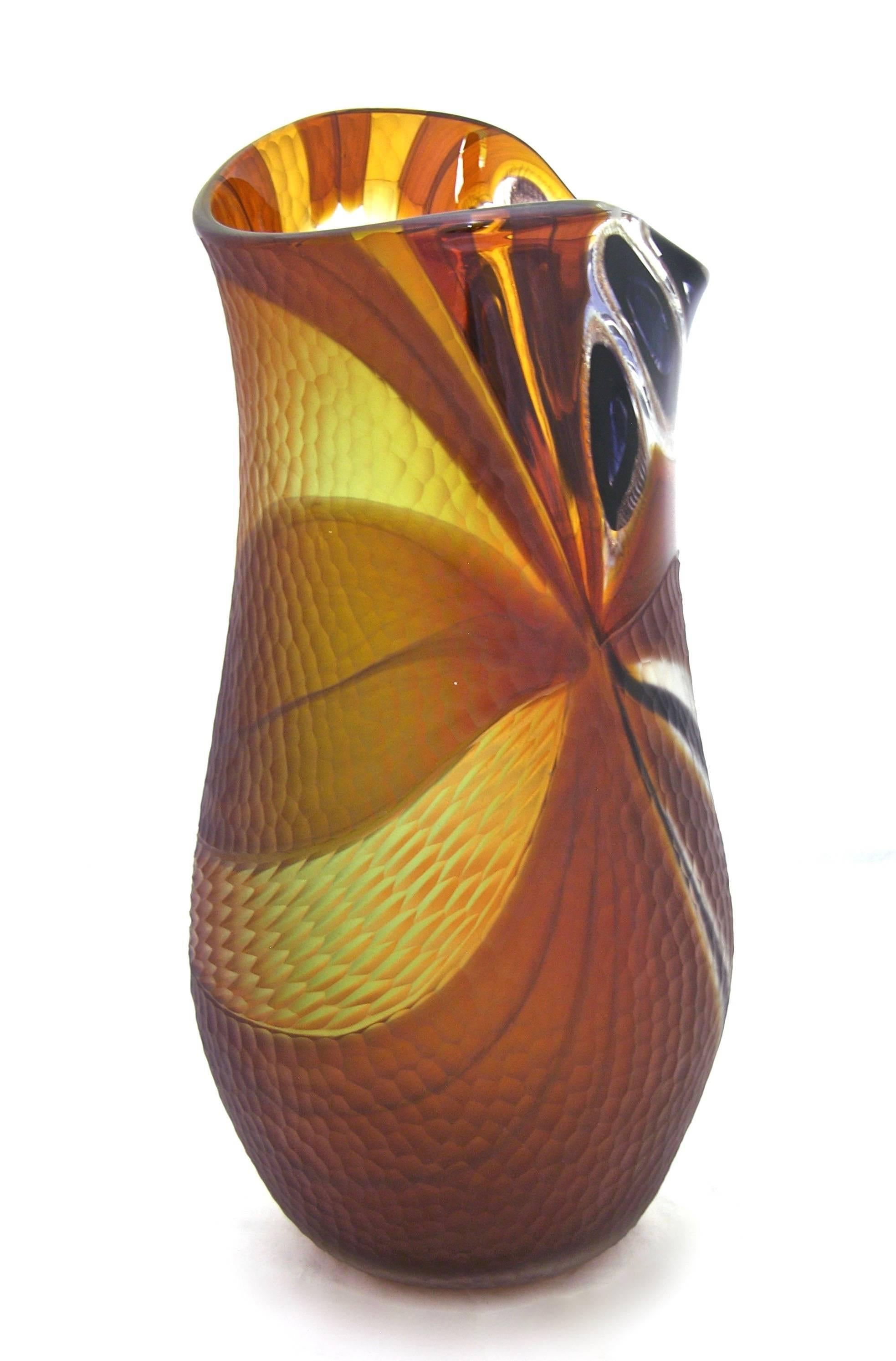 This 1990s unique blown vase in Murano glass shows an exceptional work for the fabulous jewel like colored murrine on one side, in blues, black, amber, yellow, that are highlighted with pure gold in the glass, for the several areas decorated with