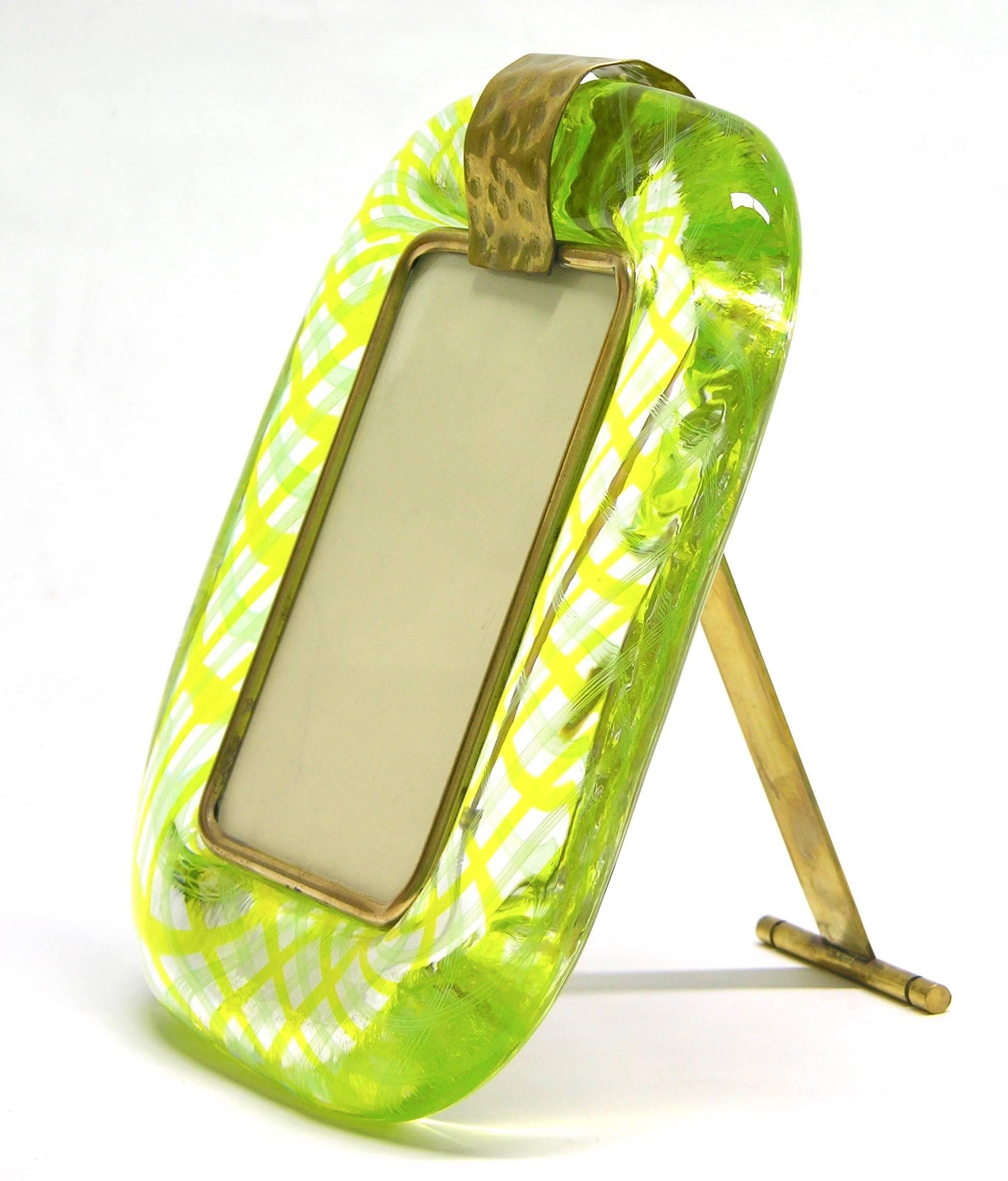 Extraordinary modern design picture frame in thick blown Murano glass by Venini, signed piece, highest quality of execution, worked with an intertwined filigrana inside the clear glass in a rare yellow color with lime reflections, the texture