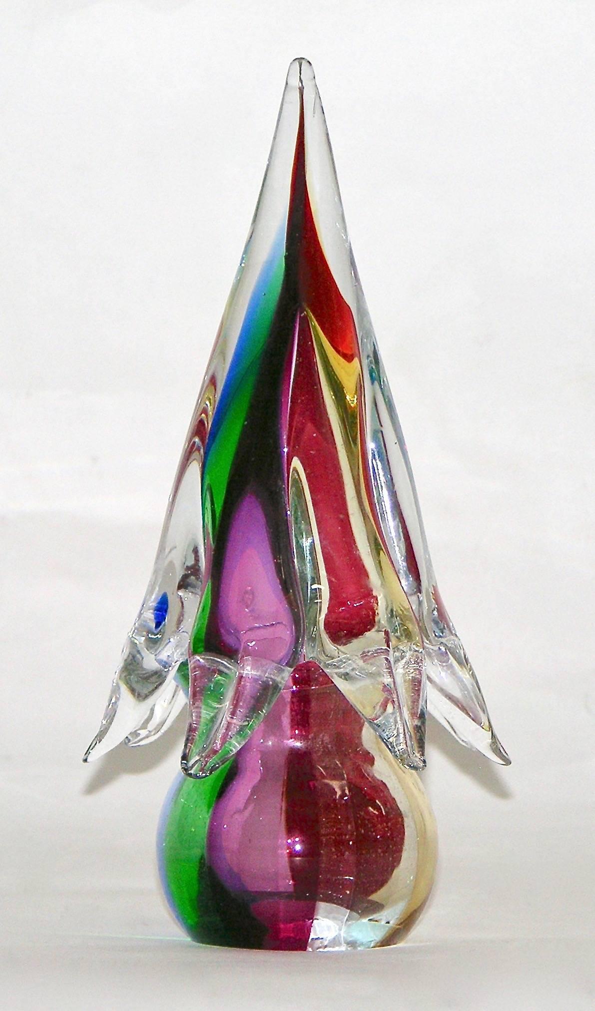 Colorful Venetian glass tree of minimalist shape, blown and handcrafted in overlaid clear Murano glass worked with incalmo, the different colors, red, green, blue, yellow, one next to the other in a joyful pattern make them glow like Christmas tree.