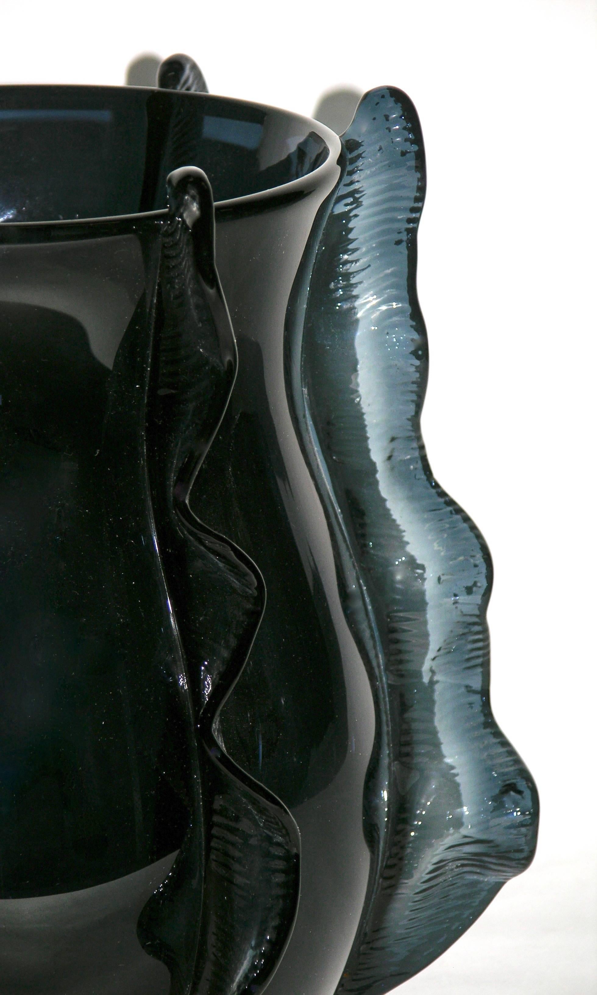 A Venetian pair of organic vases in blown Murano glass, created in a very rare avio blue color, the bombe´ shape sensually enhanced with waved handcrafted incised decorations in relief, like frills in motion that embrace and lift the design. Signed