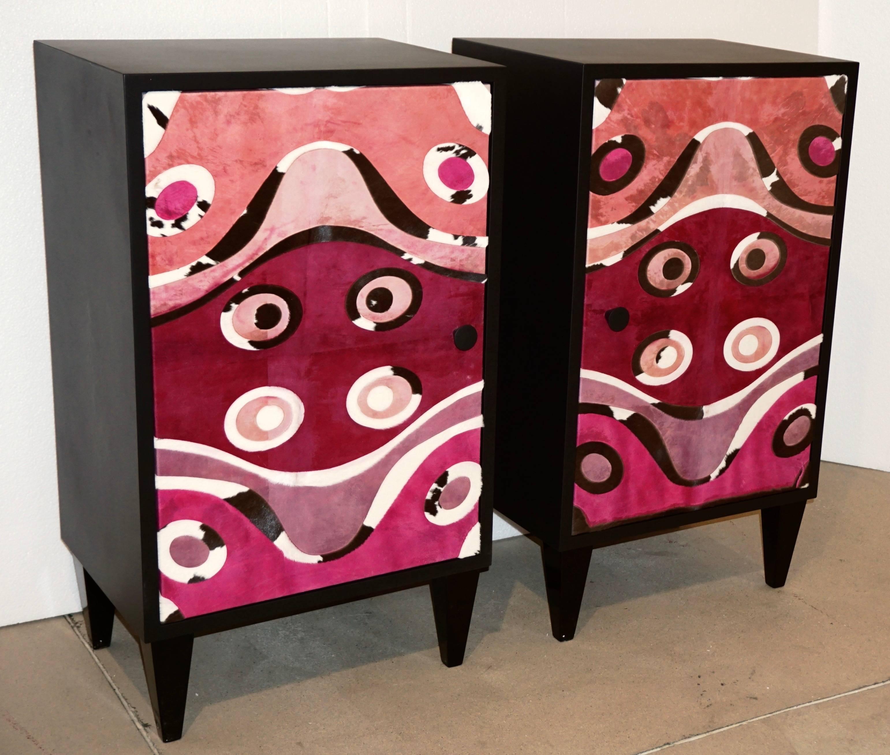 Contemporary fine design Italian pair of satin black lacquered side cabinets or nightstands raised on tapering wood legs, entirely hand made in Italy exclusive to Cosulich Interiors, the front crafted and decorated with a printed modern ethnic