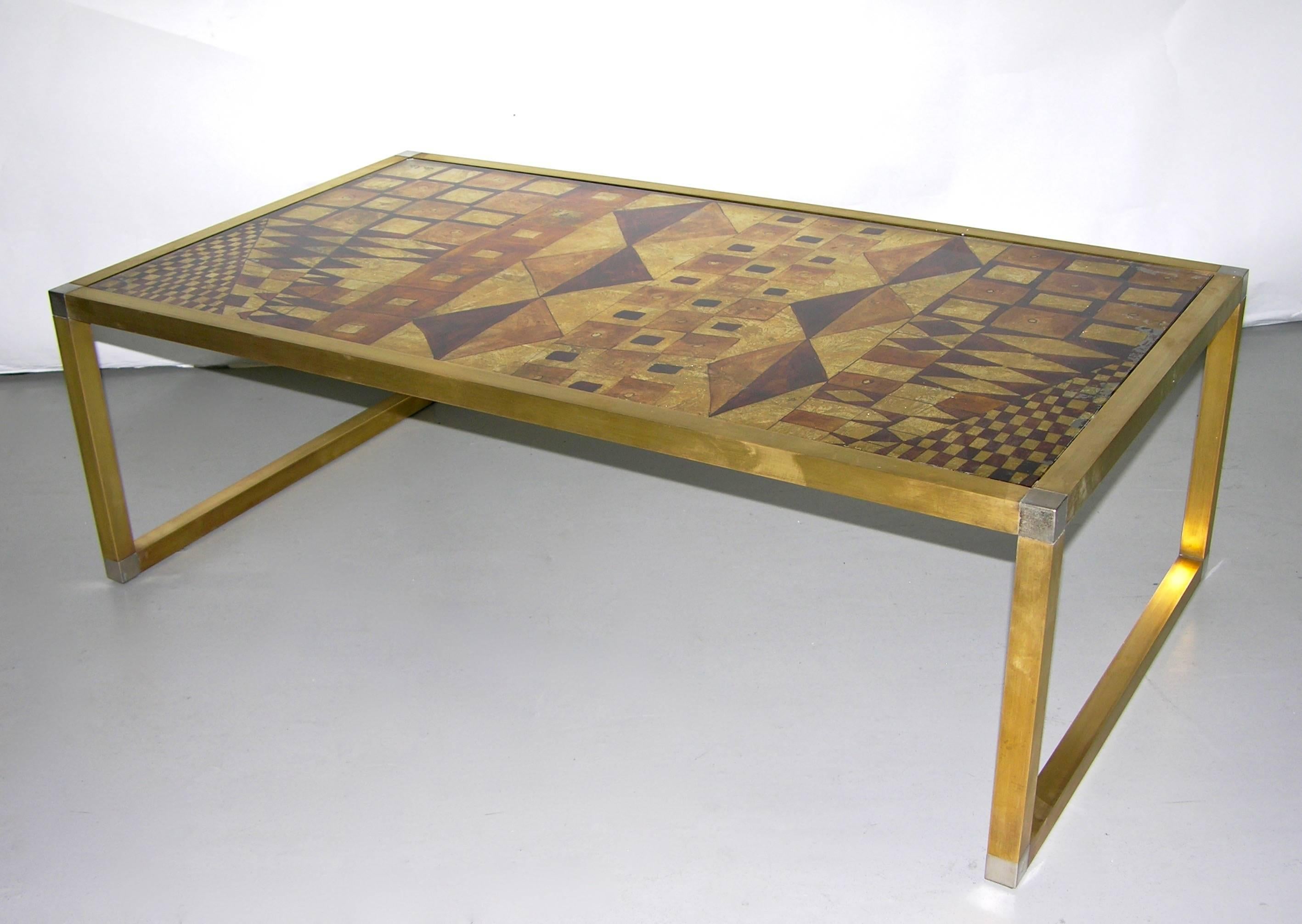 Italian one-of-a-kind 1970s low table of modern shape, a unique piece hand gilt and signed by Rita Lois, Italian painter and artist. The Art Deco inspired eglomise pattern created with different shades of pure metallic gold leaf like a geometric