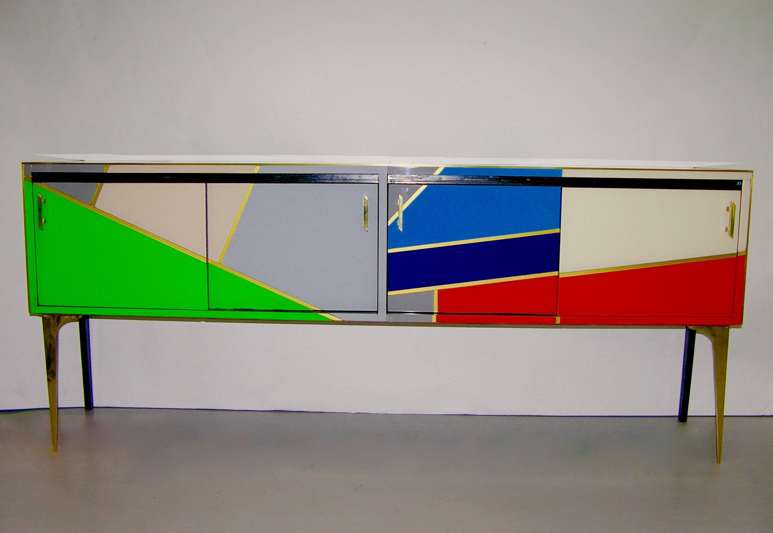 This unique Italian sideboard of exceptional colorful fine design with a Mondrian flair is entirely handmade and presents many details of the highest quality of craftsmanship: each segment of color is edged in bronze, the handles in cast bronze are