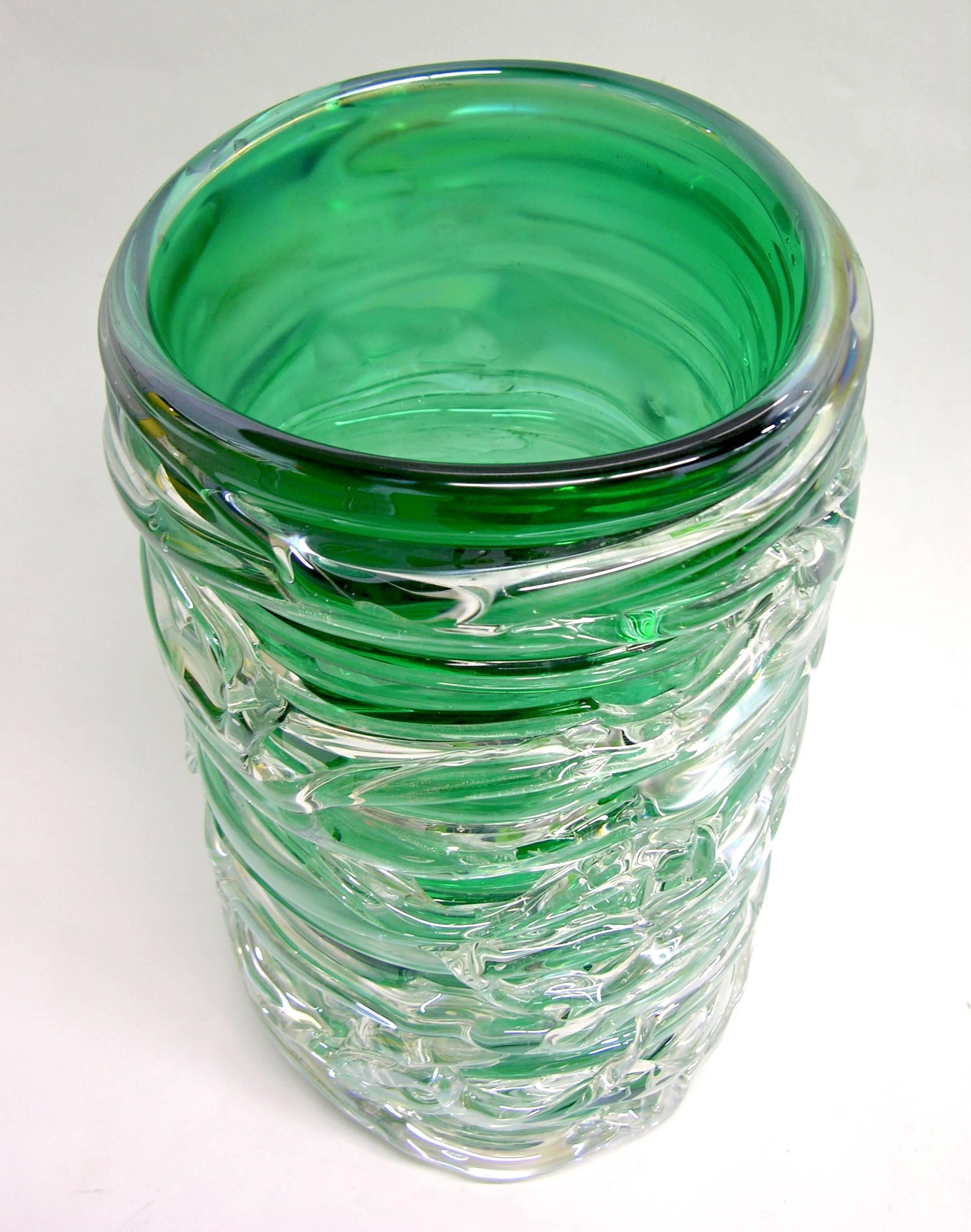 Stunning early 1980 vintage high quality Murano glass vase, unusual deep emerald green body worked with a magnificent iridescence, the body wrapped in clear glass threads freely hand applied in a delicate raised pattern. Signed Camozzo.
