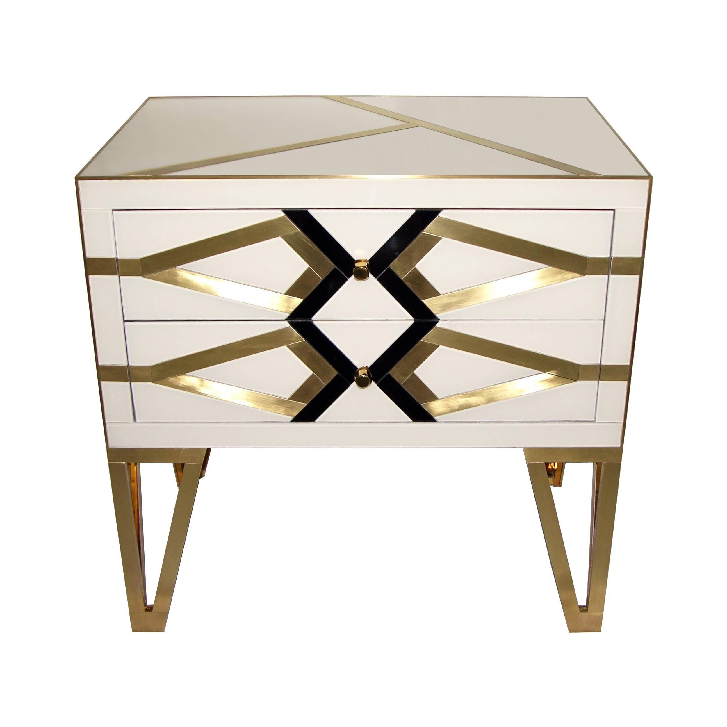 Italian pair of two-drawer commodes or nightstands, one-of-a-kind contemporary work, entirely handmade showing high quality and elegance of execution: The surround in ivory white is decorated with a geometrical abstract pattern in black glass and