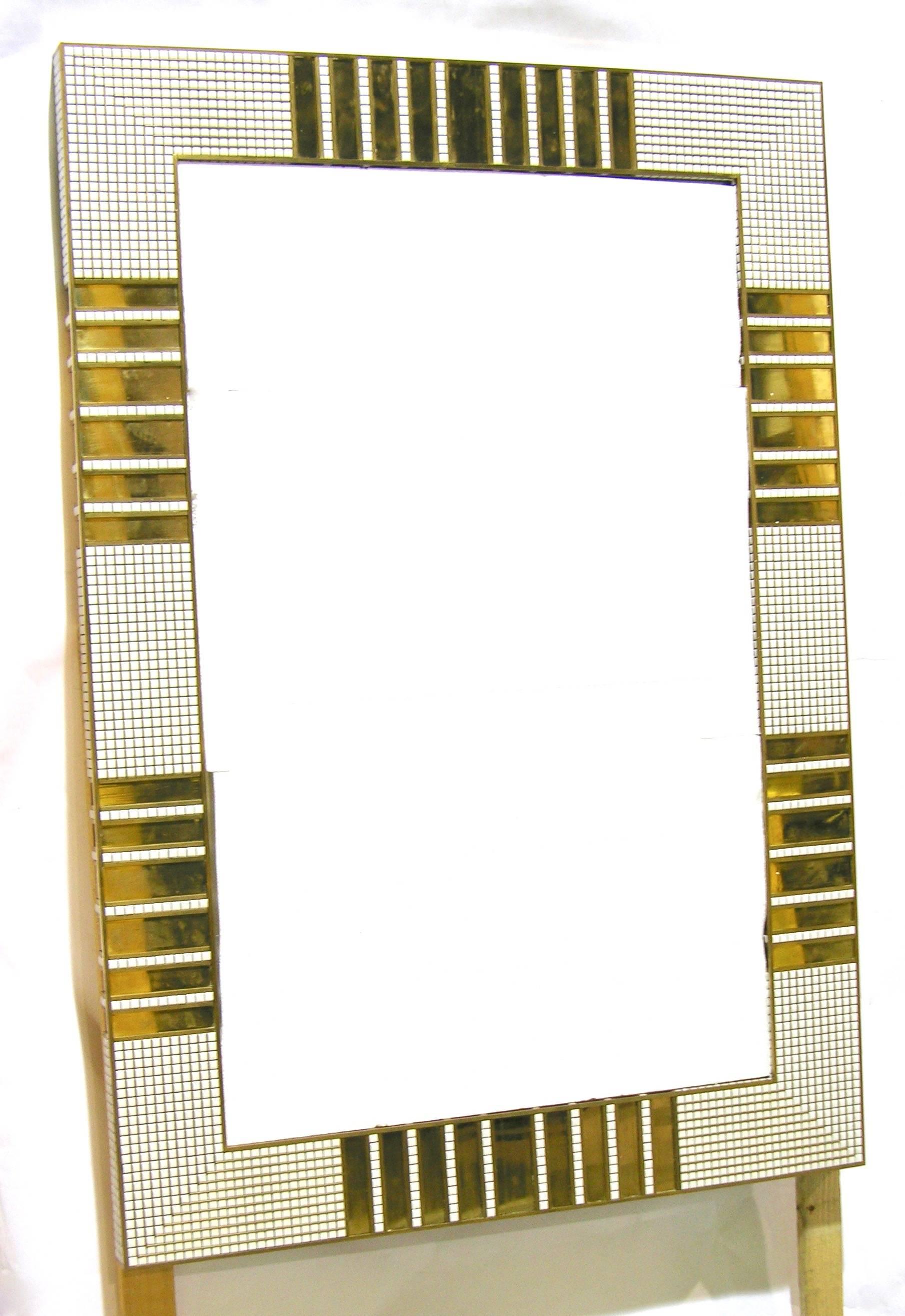 Late 1970s one of a kind exceptional Italian mirror entirely decorated with a mosaic of small white ceramic squares. The design is enhanced with inserted handmade brass bands, the execution is of the highest quality with refined brass lines