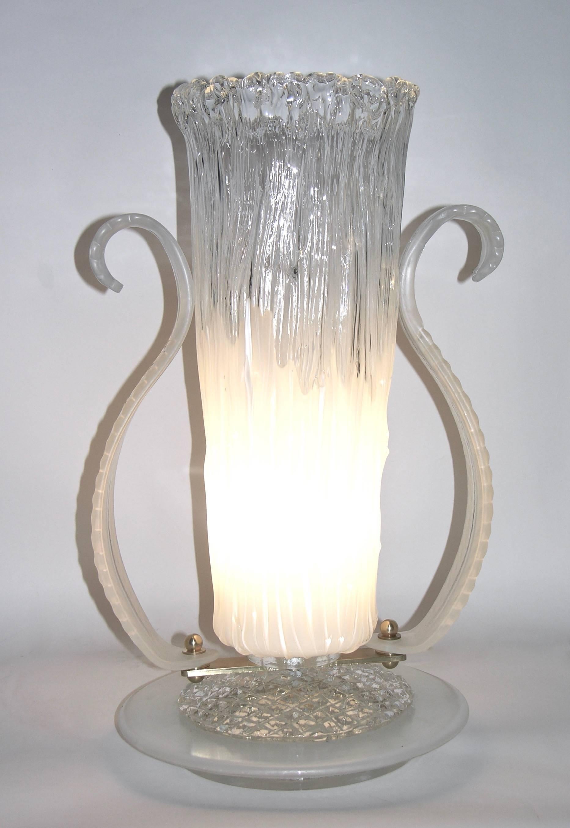 Highly elegant Art Deco style grand pair of tall Italian table lamps in blown Murano glass, the bodies worked with a sophisticated technique to create a pinched ruched texture are in white glass that defuses in clear to the top resembling an ice