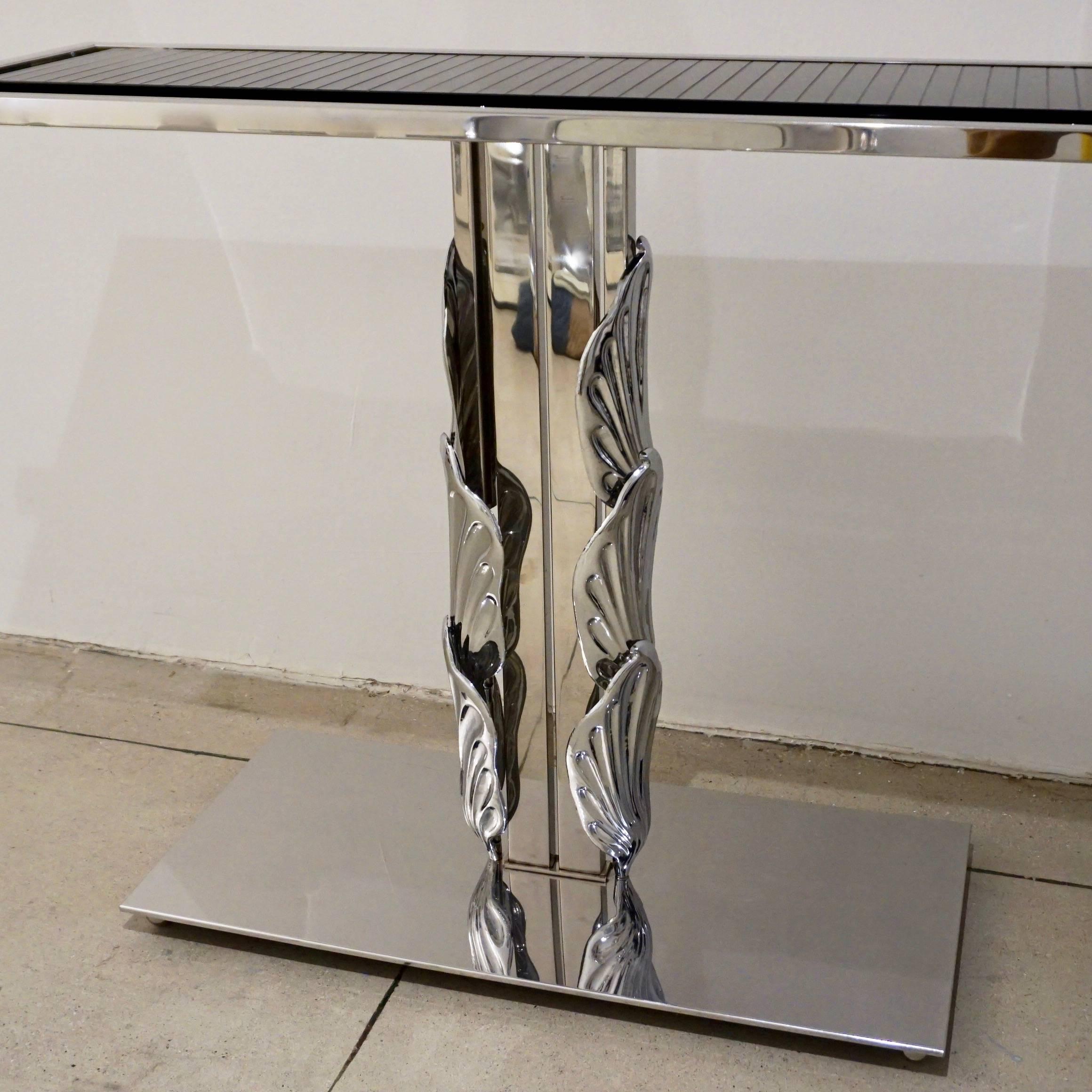 A pair is available - one-of-a-kind Modern Italian silver color nickel central console of unique and exclusive transitional design, entirely handmade, the central support adorned by hand chased polished chrome elements with shell or stylized leaf