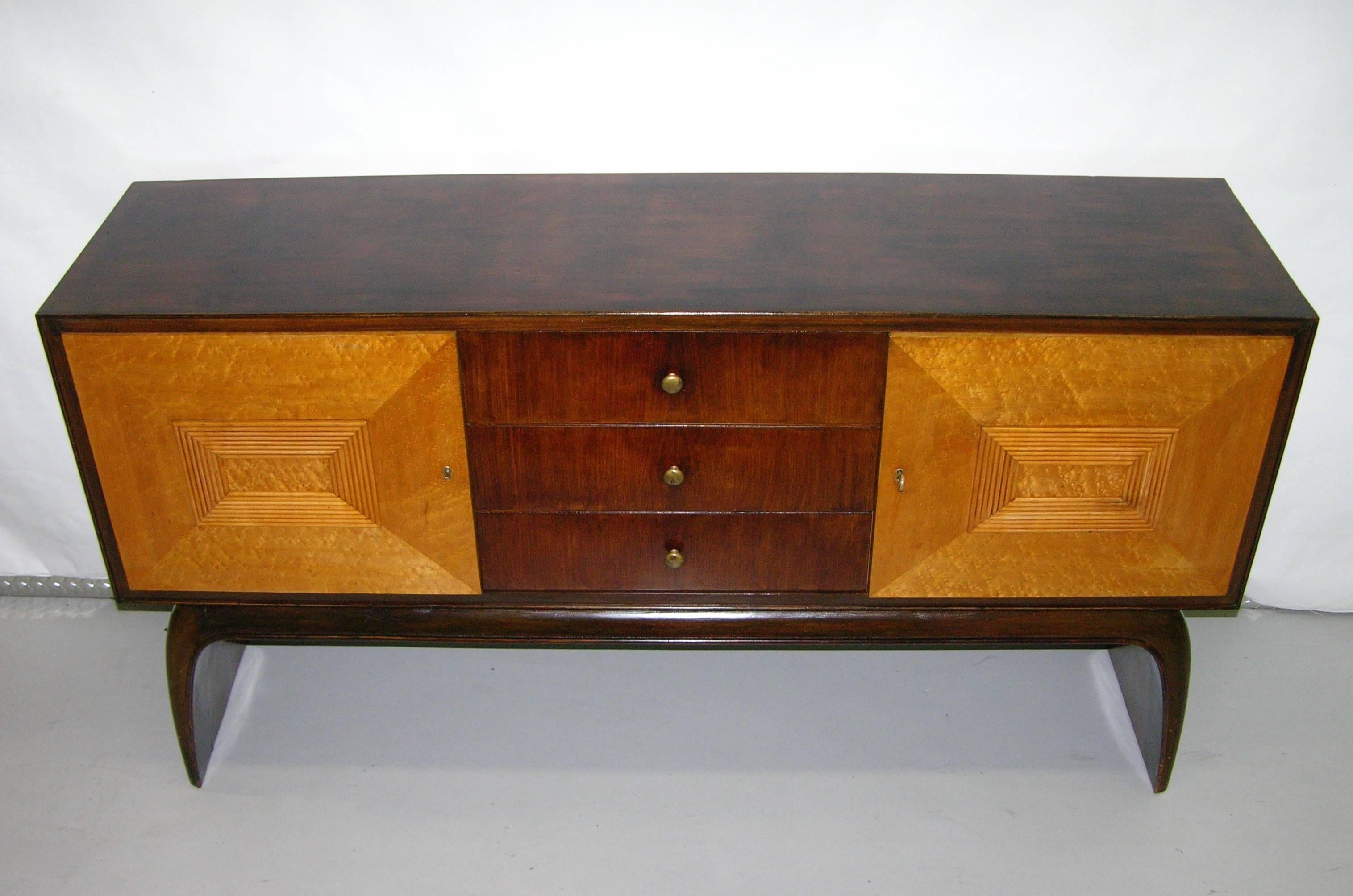 A very elegant Art Deco Italian sideboard or credenza, entirely handmade in two tones: veneered rosewood for the surround, the three central drawers and the chic waterfall base while the side doors in relief are in burl maple decorated with a raised