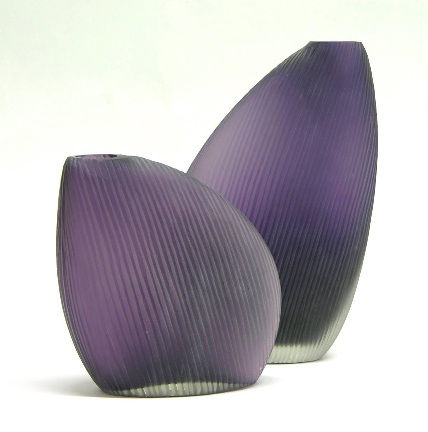 Very elegant vintage vases in different heights by Vistosi, of modern design and sleek interesting shape in a subtle purple Murano glass overlaid in clear, the body is hand ground with vertical lines resulting in a raised organic texture and