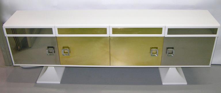 A very rare and unique Italian design for this sideboard or cabinet by Sandro Petti for L'Angolo Metallarte, 1970s, Rome. A sculptural work with four front doors in two different finishes: Chrome and brass enhancing the white lacquered wood