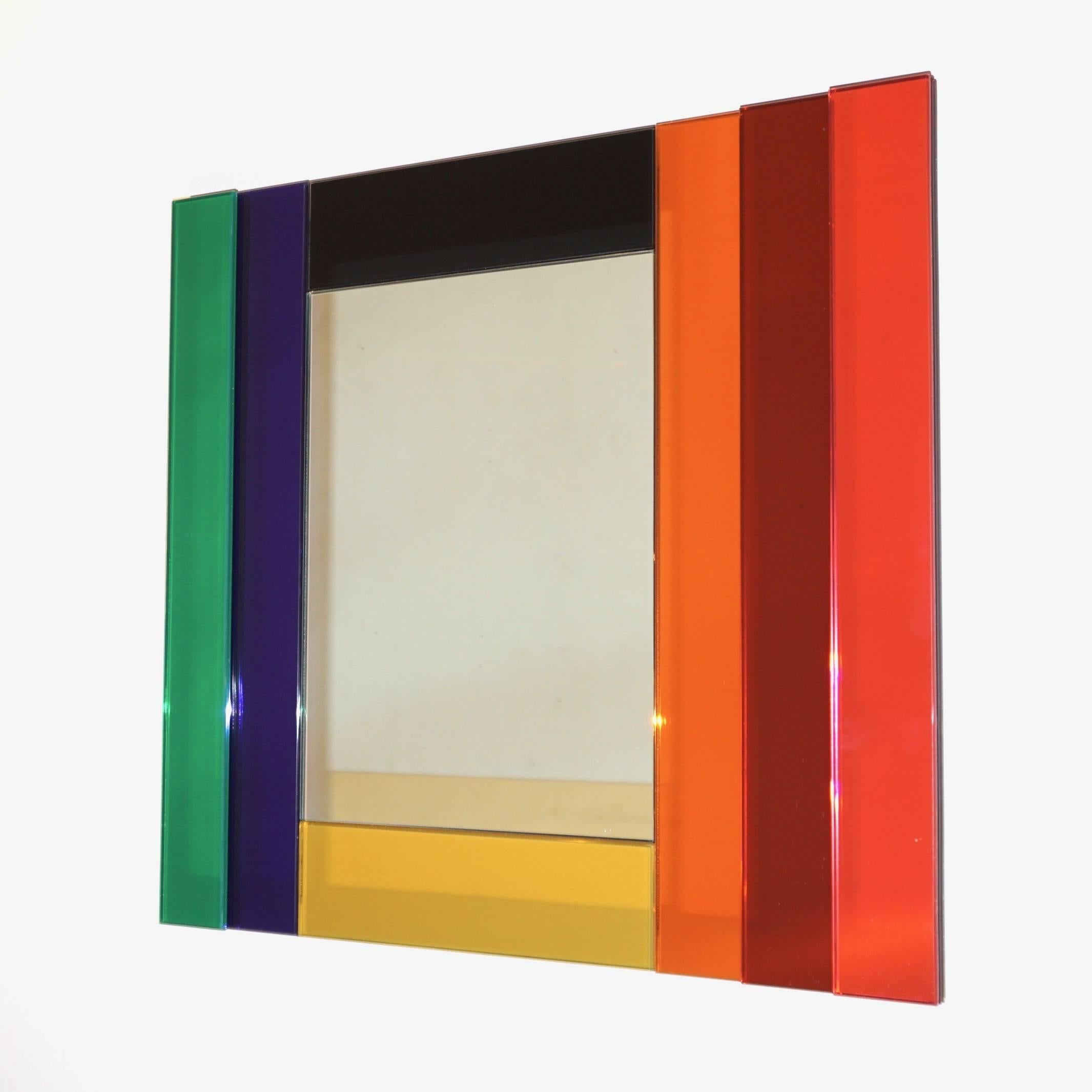 A modern Minimalist polychromatic rectangular mirror, circa 2008, from the collection Gli Specchi di Dioniso designed by Ettore Sottsass and produced by the Italian Company Glas Italia in Brianza. The mirrored plate is surrounded, to create drama in