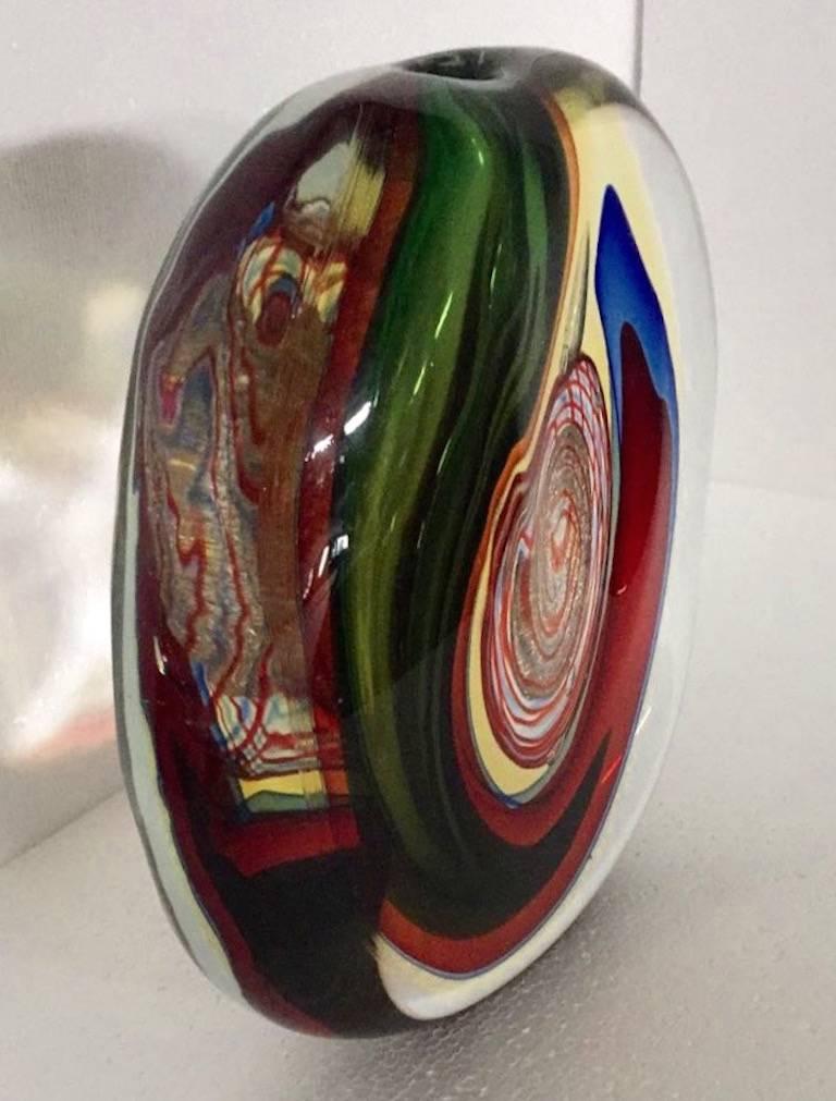 Sophisticated Italian Work of Art by Alfredo Barbini, a sculptural vase of very organic stone shape, worked like an abstract painting, the crystal clear blown Murano glass encloses layers of Sommerso colors, blue, red, green, yellow and a precious