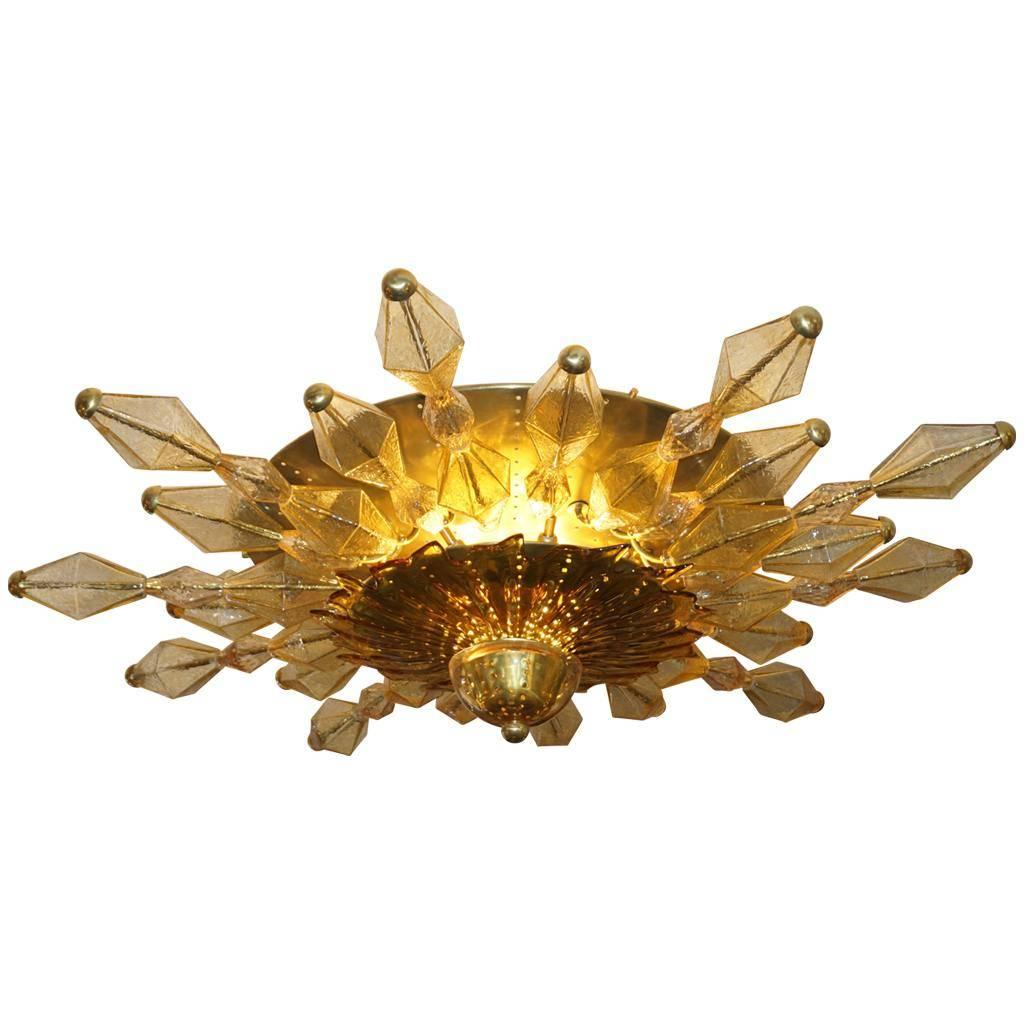 One-of-a-kind vintage Italian Fine Design ceiling light, entirely handcrafted with an interesting radiant sun shape. This flush mount gives plenty of light with 16 candelabra bulbs: the round two-tiered brass structure has 7 bulbs in the upper