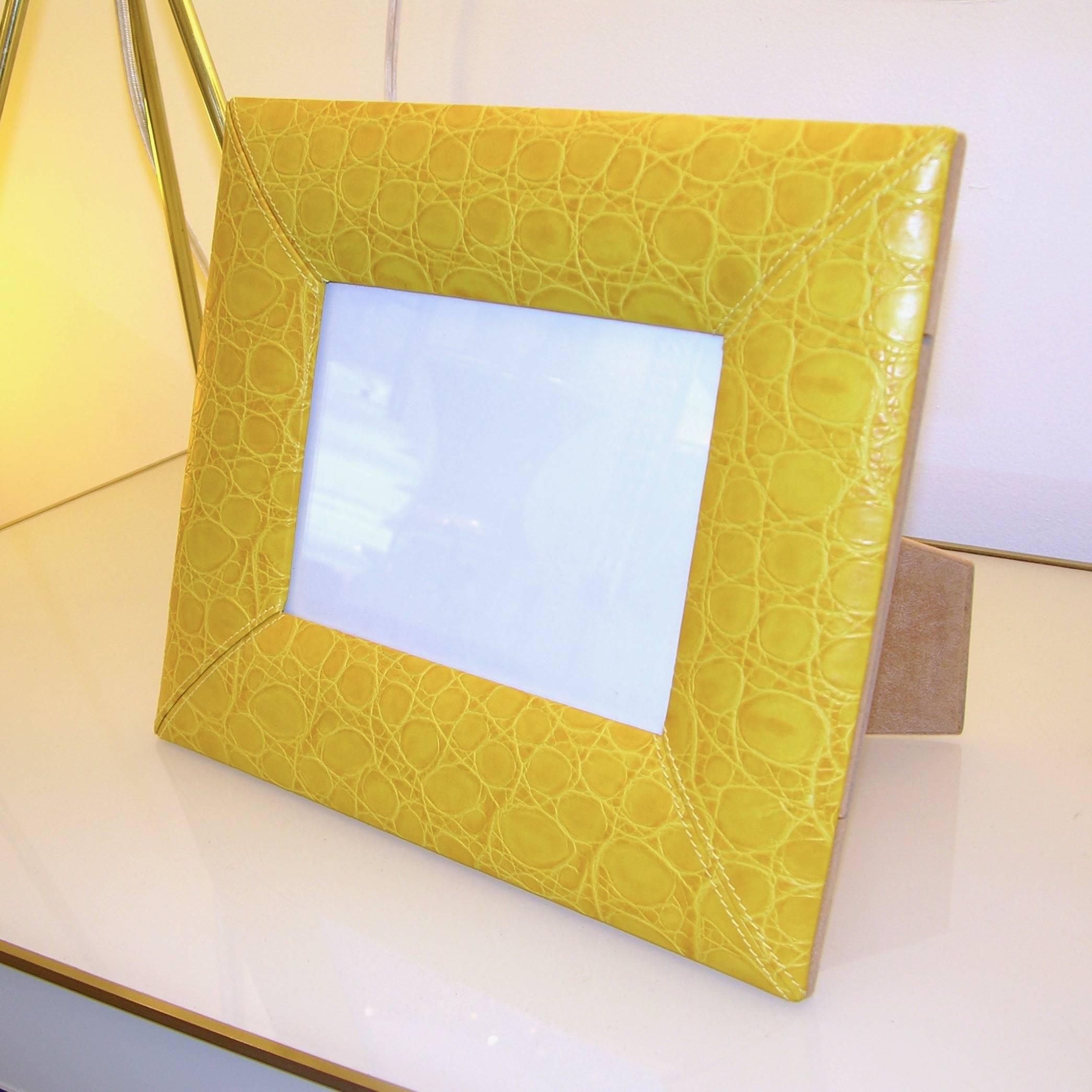 Modern photo frame of clean design, signed by the fashion designer Cesare Paciotti, high quality of Italian handmade execution, in stitched embossed leather in lemon yellow color, with beige felt back.
Photo placement measures: 6.75 x 4.75.
Can