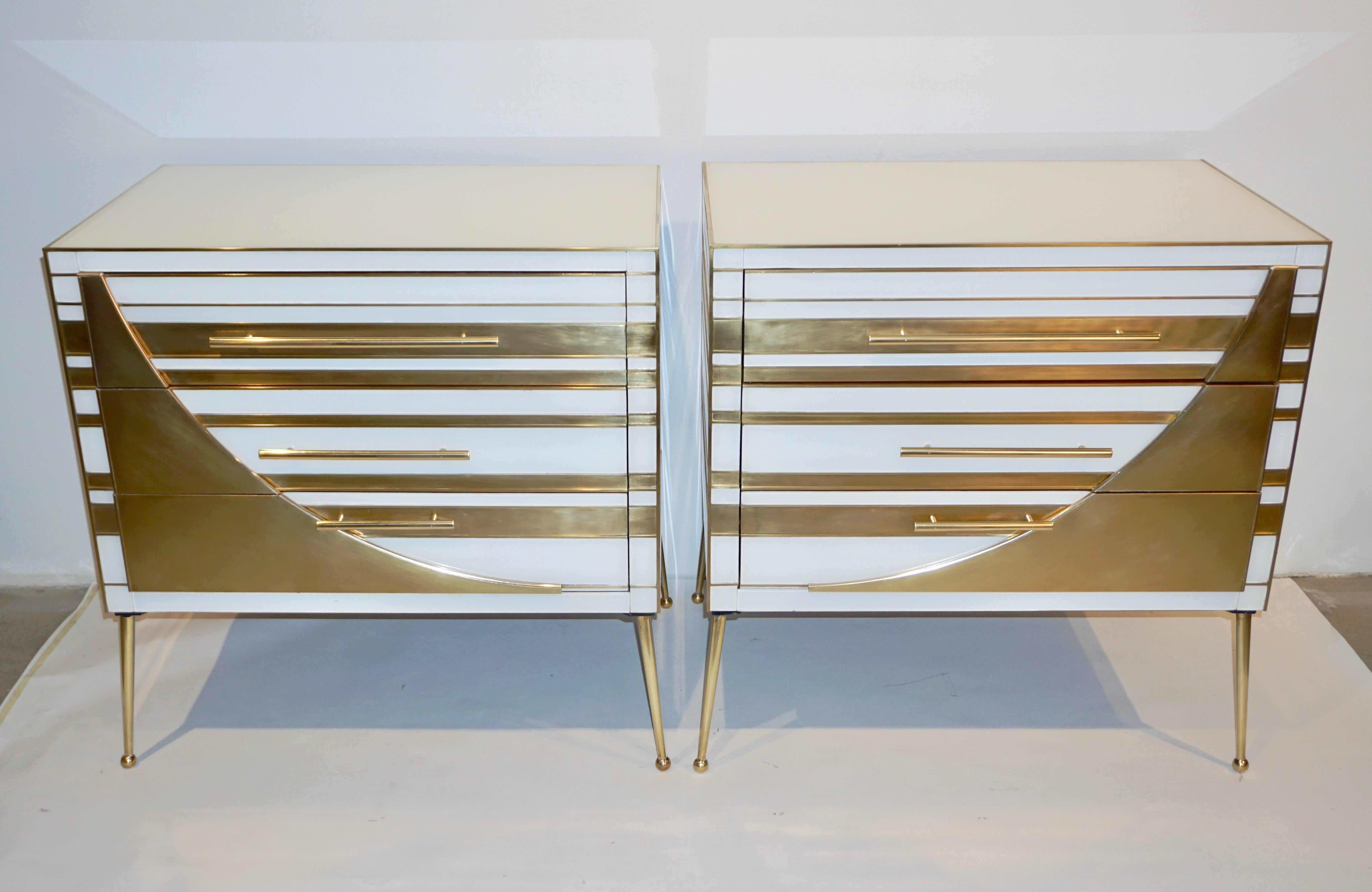 This Italian exclusive pair of modern chests, that can be used as end, side tables or nightstands, present a unique Art Deco Style fine design, quality of construction and use of mixed material techniques: metal and glass on wood. Entirely