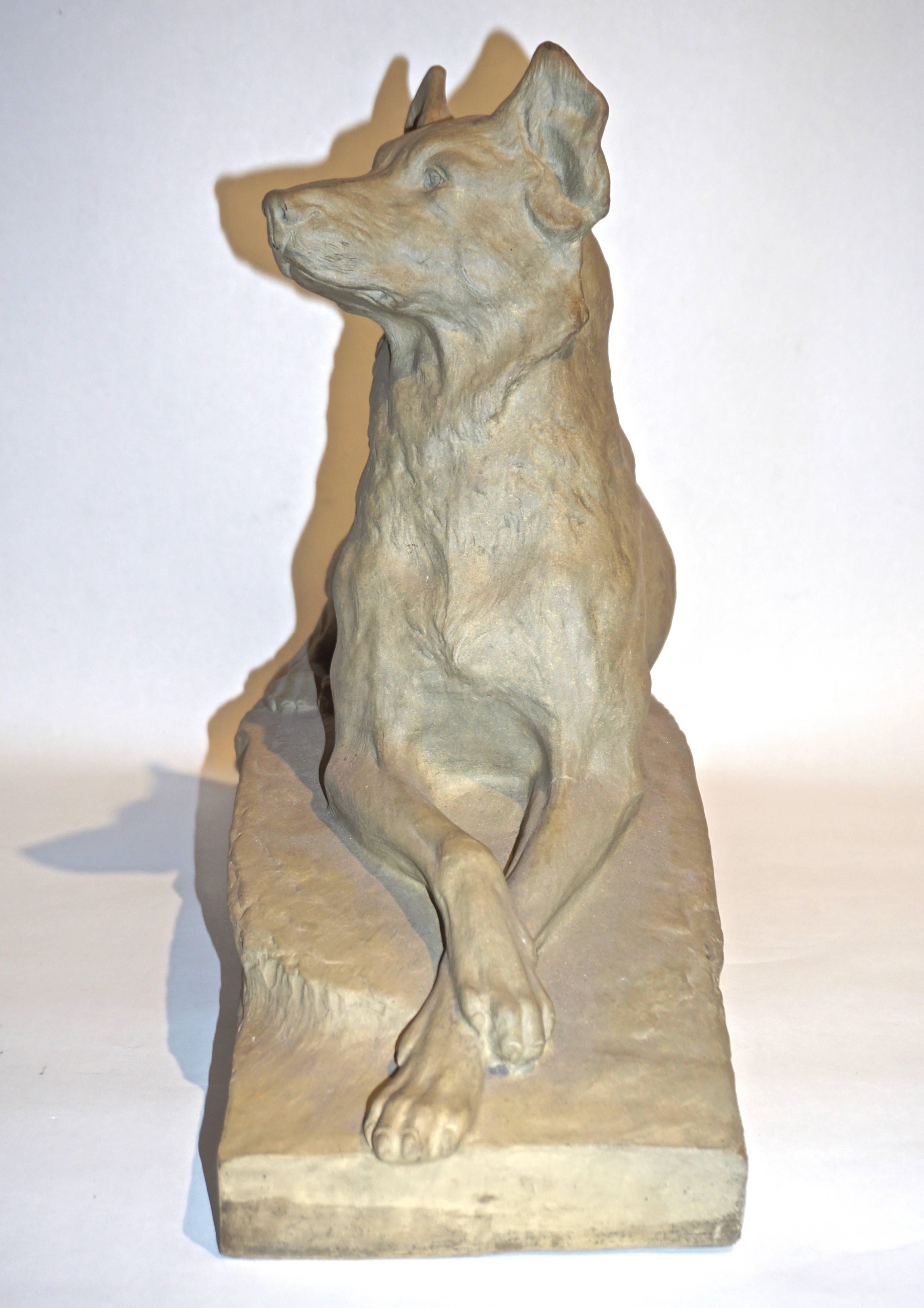 A dog sculpture, circa 1920, representing a sitting German shepherd, by the animalier Charles Virion pour Rambervillers, the renowned Art Nouveau French Art Pottery, in grey clay, bearing engraved signature.
Charles Louis Eugène Virion (1865 -