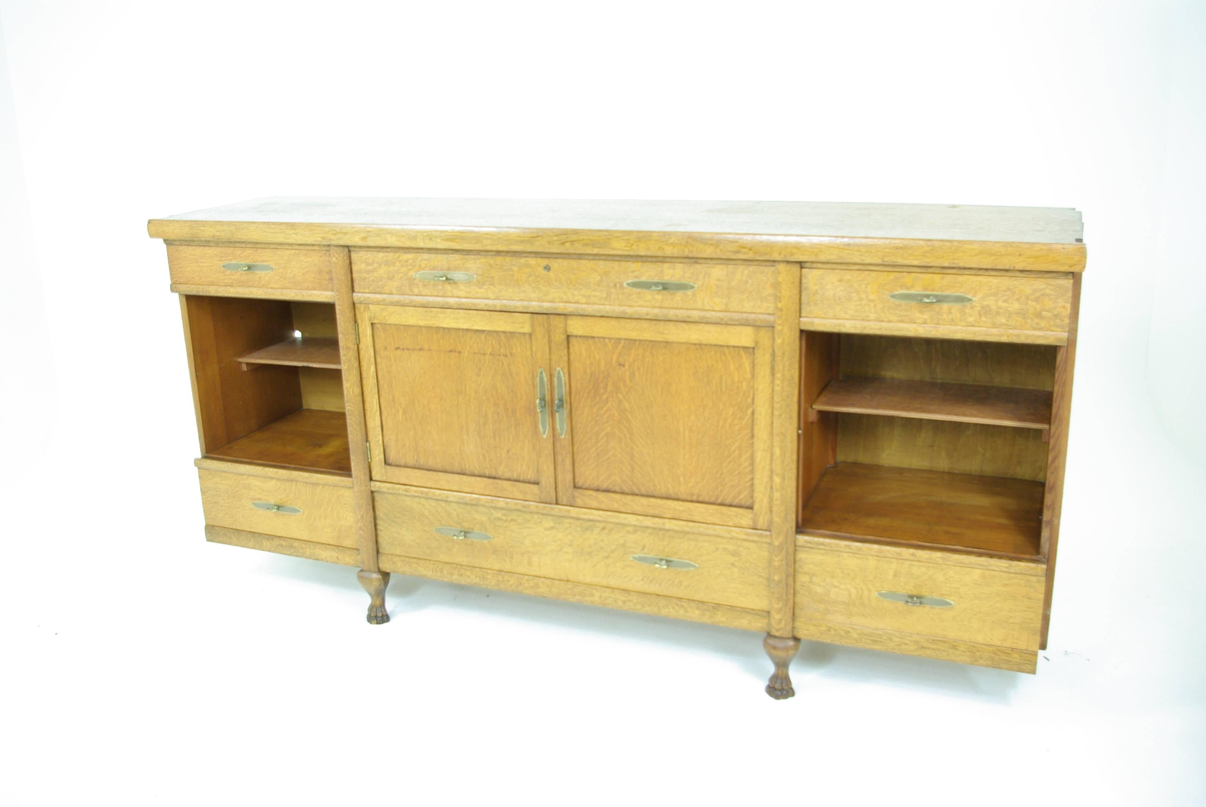 America, 1910.
All original tiger oak construction.
Stained glass original.
Separates into three pieces.
Central sideboard with drawers and cupboards.
Flanked by China, cabinets with three adjustable shelves ending on claw feet.
All solid when