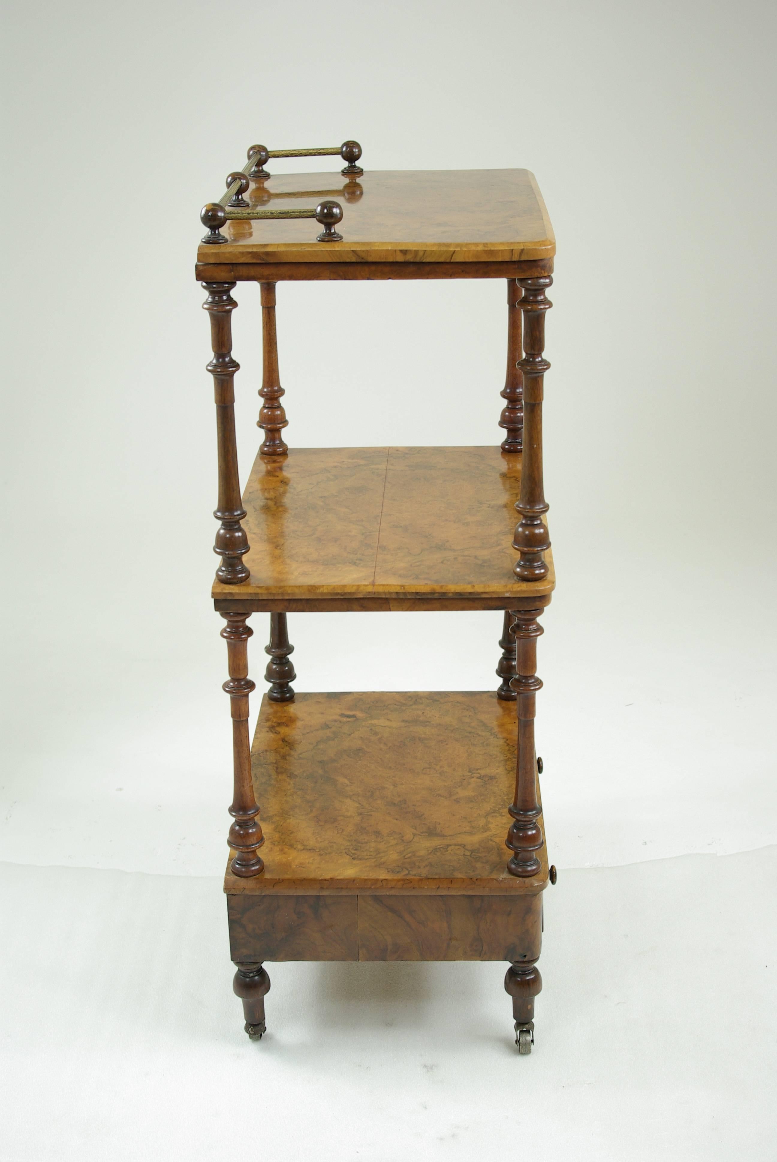 Scotland, 1870.
 Original finish.
 Lovely quality.
 Brass gallery above.
 Two shelves below.
 Single drawer at the base.
 Original castors.

 $875.

 
 Measures: 22.5