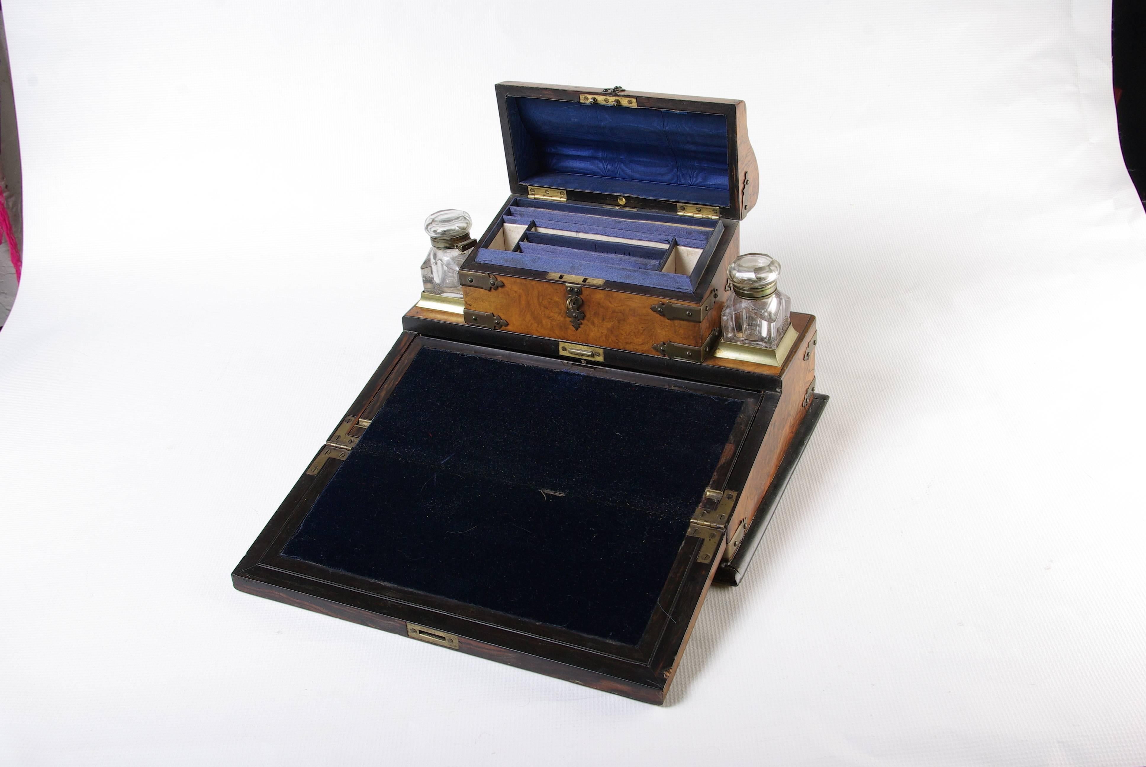 England, circa 1870.
All original condition.
Having a lift top letter holder, flanked by a pair of inkwells
fold down writing surface
below lift up writing slope is a secret compartment with original leather and pidgeon holes.
Original brass