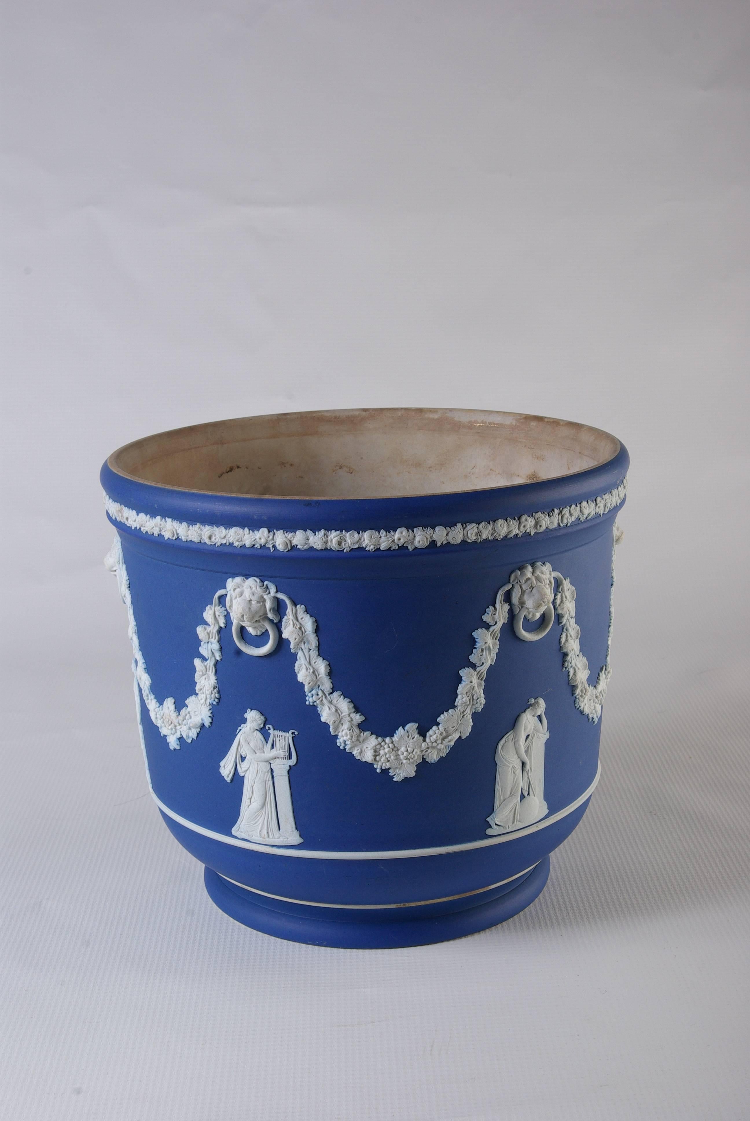 B-383F large Wedgwood jasperware jardiniere cache pot, white over cobalt blue.
Marked on underside Wedgwood, England.
Lions head with classical figures.
No losses to the decoration.
Some interior staining.
No chips, cracks or