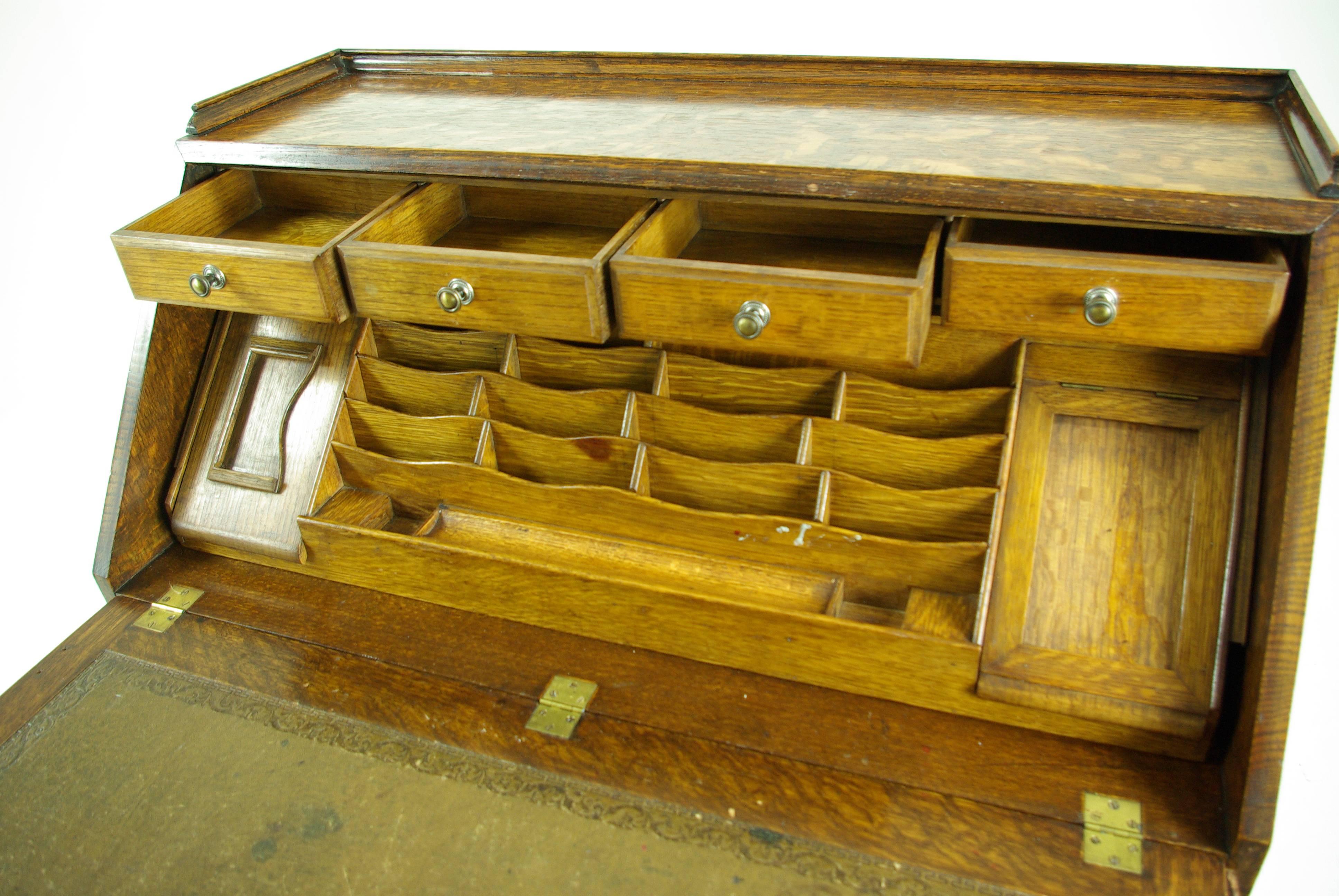 Scotland,
1920.
Solid tiger oak construction.
Original finish.
3/4 gallery top.
Carved panel slant front door.
Fitted interior with dovetailed drawer
Tooled leather writing surface.
Three serpentine front drawers with original brass hardware.
Ending