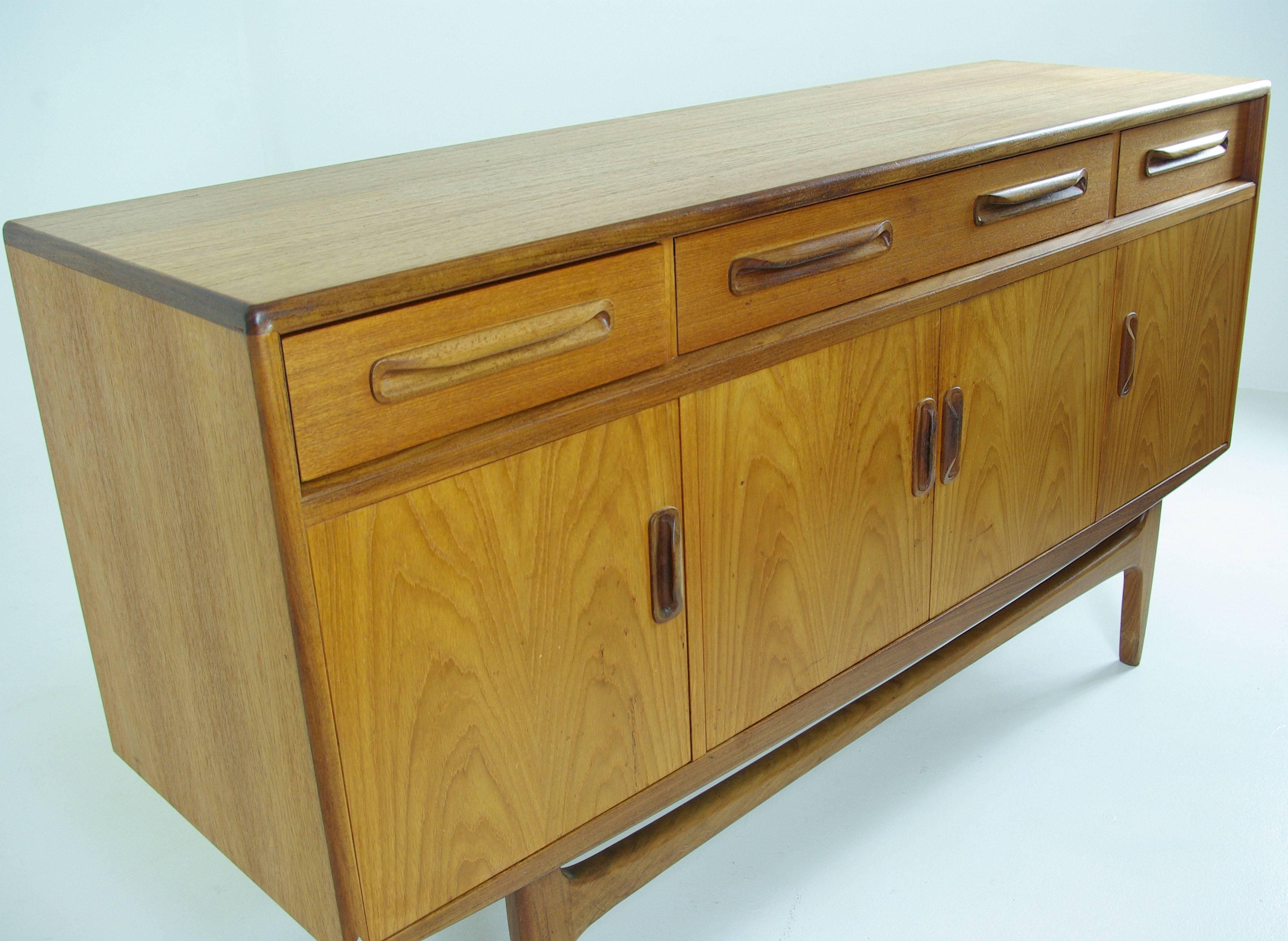 Scotland, 
1960.
Original finish.
Rectangular top.
Large central drawer flanked by two smaller drawers.
Nicely shaped handles.
Three cupboards below.

$1250.

B554
Measures: 60" W x 18" D x 33" H.
Shipping $475-500 with