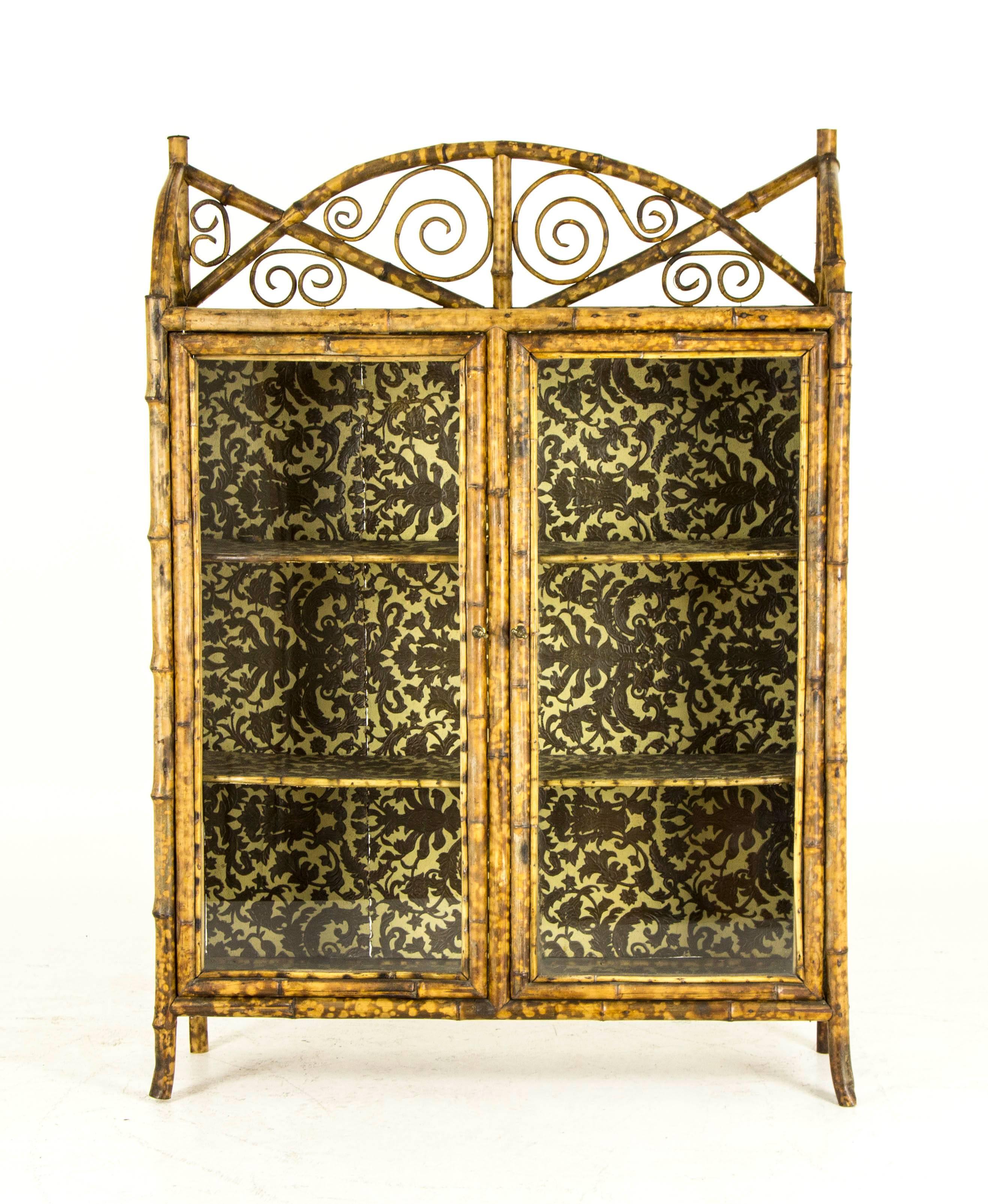 Scotland
1870
A good example in great condition
Victorians loved bamboo furniture
Three quarter gallery with accents
chinoiserie painted top above two glass doors opening to two fixed shelves
Ending on bamboo splayed legs
This bookcase