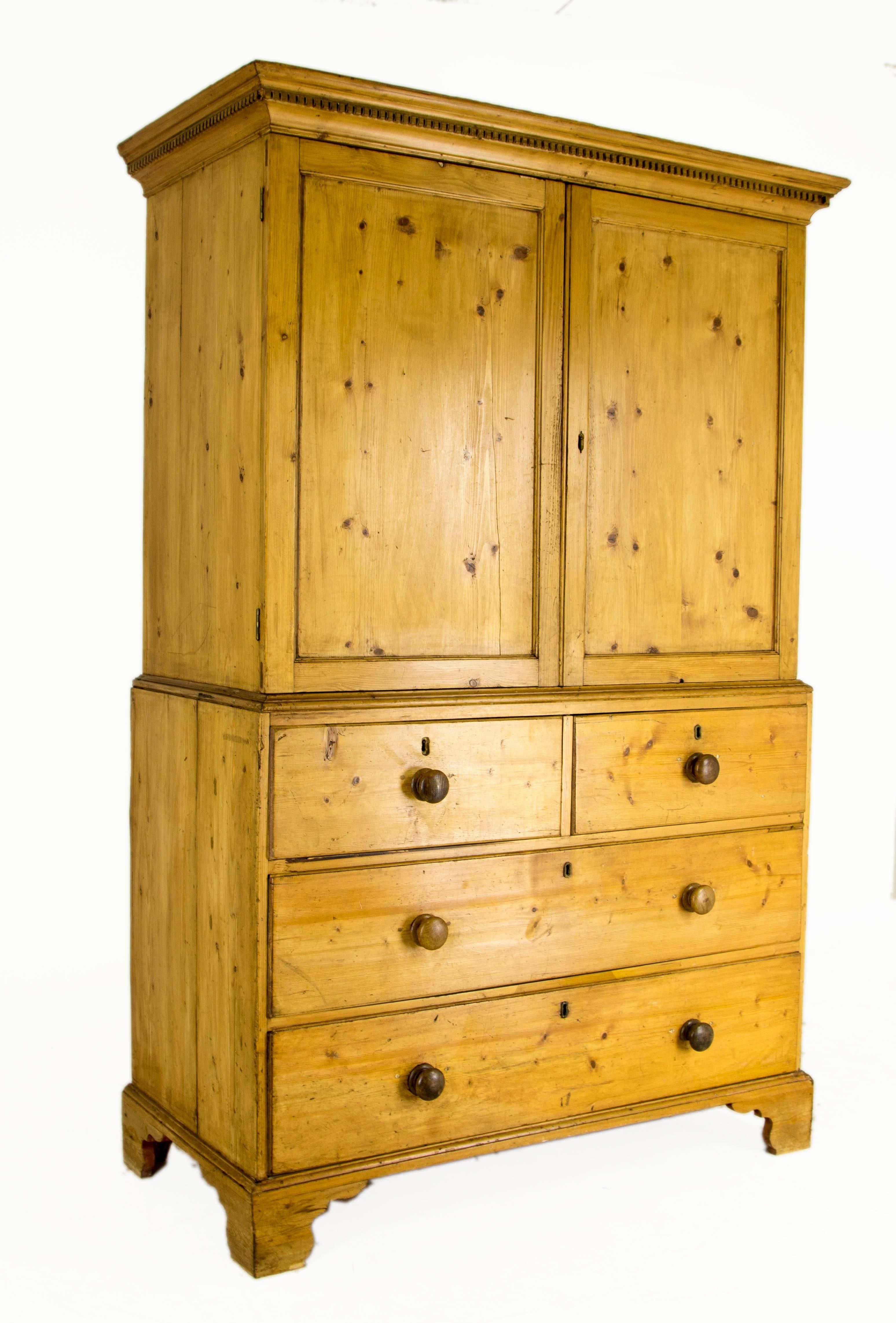Scotland, 1870
Solid pine construction
Dentil cornice above
Two large panel doors open to reveal four interior slide out drawers
The chest of drawers below has two short over two long drawers
Ending on bracket legs
Separates into two