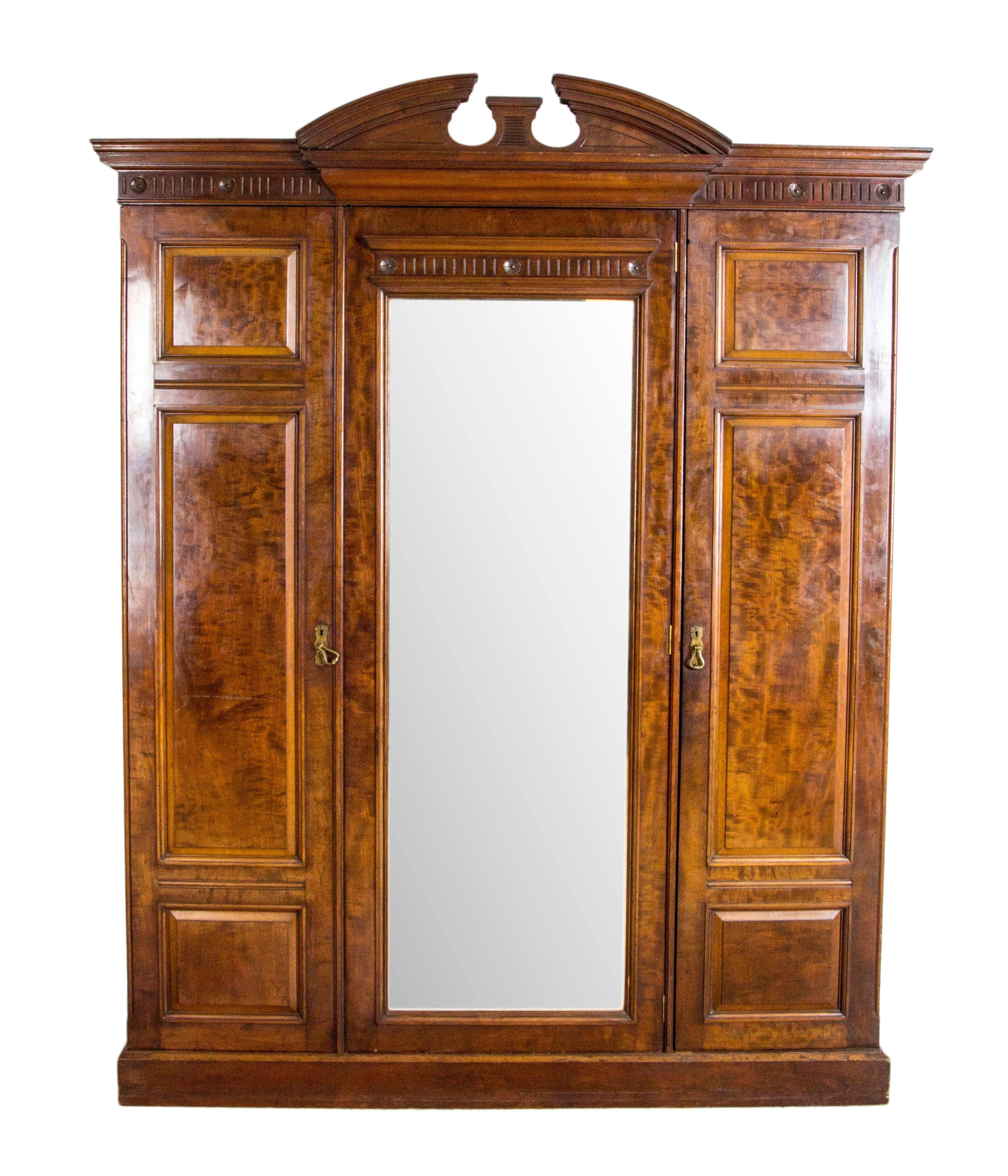 Scotland
1870
Solid walnut original finish
Carved cornice
Double door with beveled mirror
Brass rod and brass hooks inside
Single drawers below
Made by Paterson, Smith, Innes of Edinburgh
Right cabinet fitted with single shelf, three slide