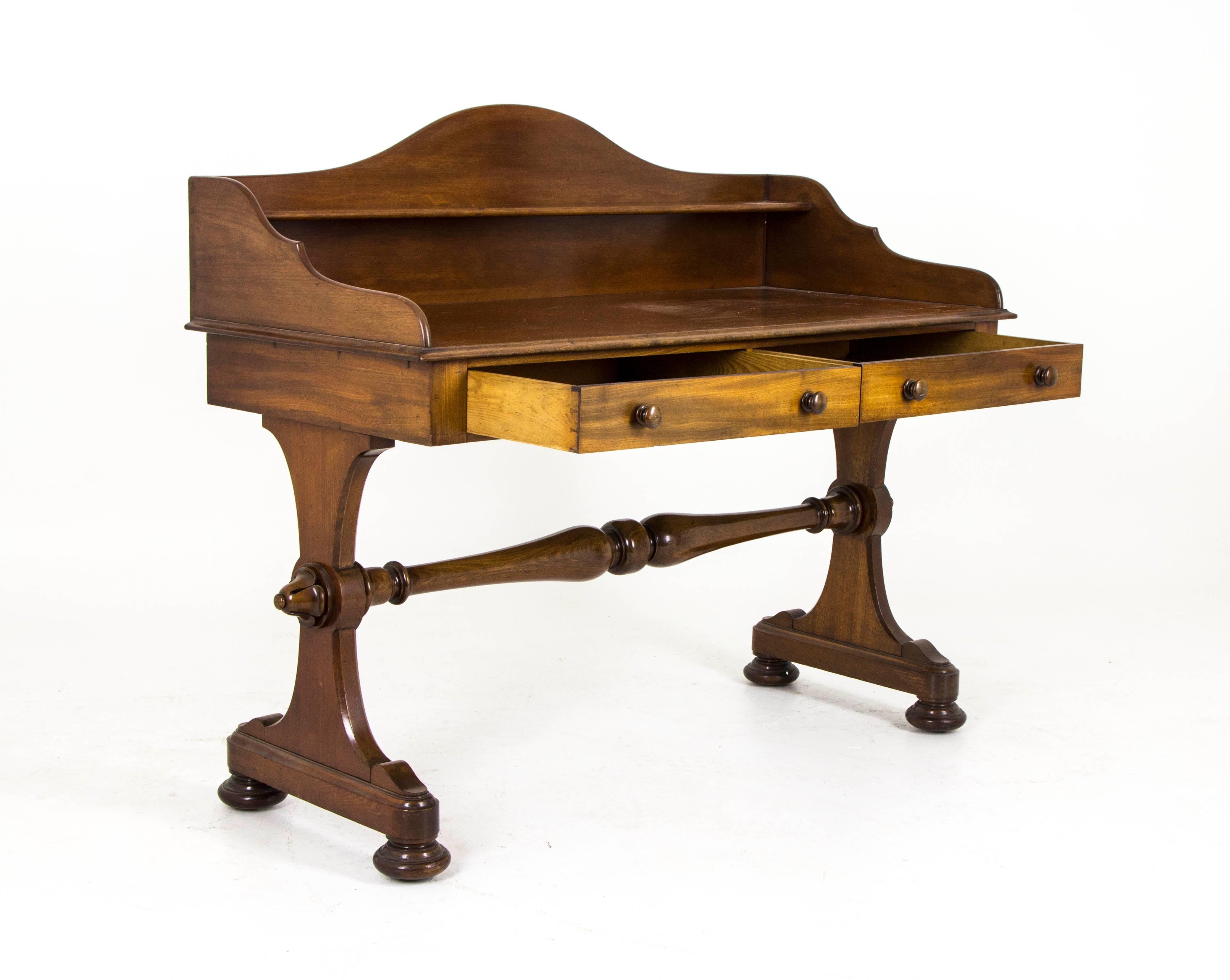 B370 large Victorian Walnut  writing table, commode with shelved back.

Scotland, 1860
Original finish
Solid Walnut 
Shelved back with sides
Two drawers with hand cut dovetails
Large turned cross stretcher
Sitting on shaped ends with original