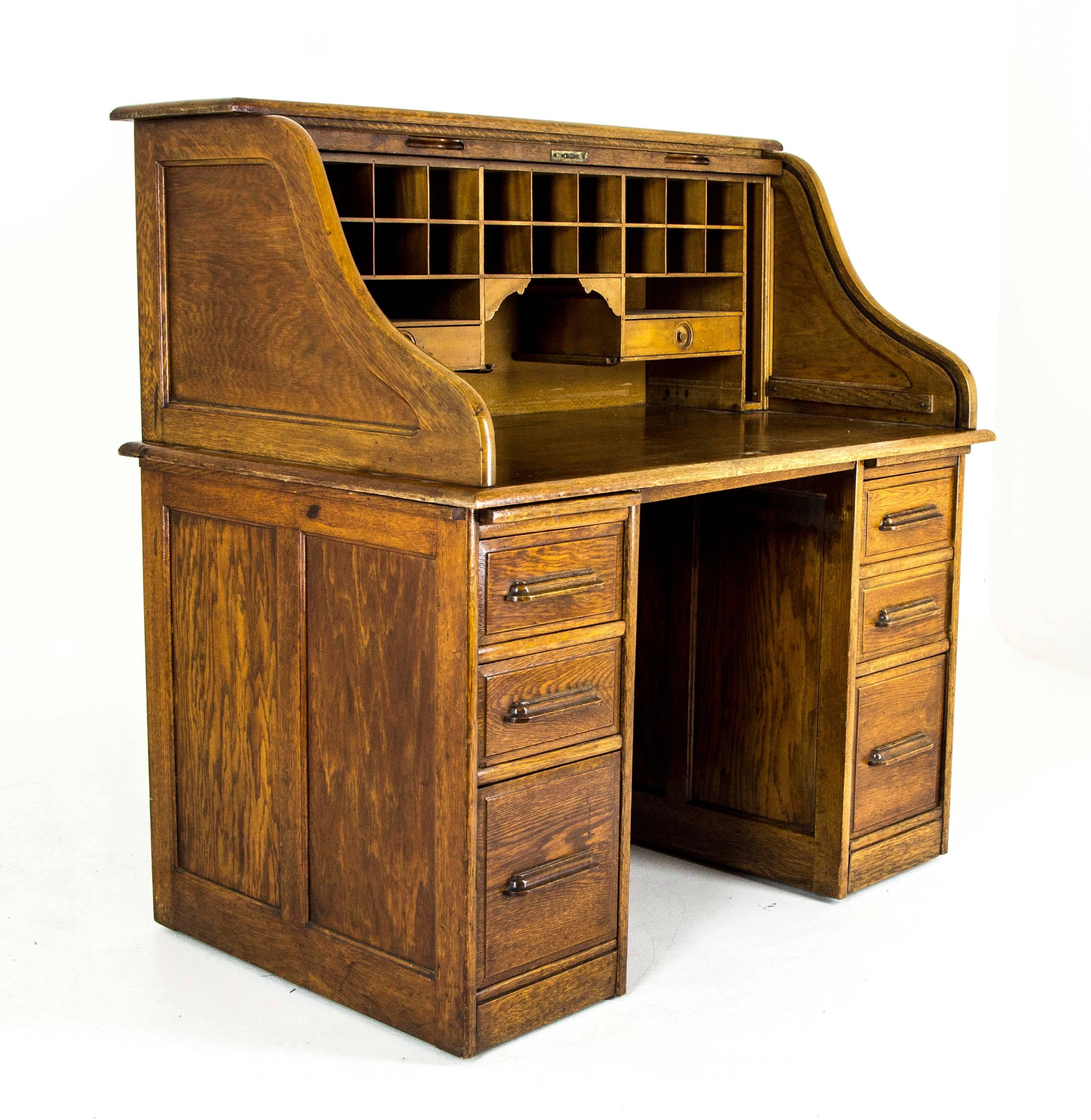 This gorgeous double pedestal roll top desk is fashioned of all original golden oak. Nearing 100 years old; this lovely antique double pedestal roll top has the original finish and lock and the drawers and roll top slide smoothly. Truly an heirloom
