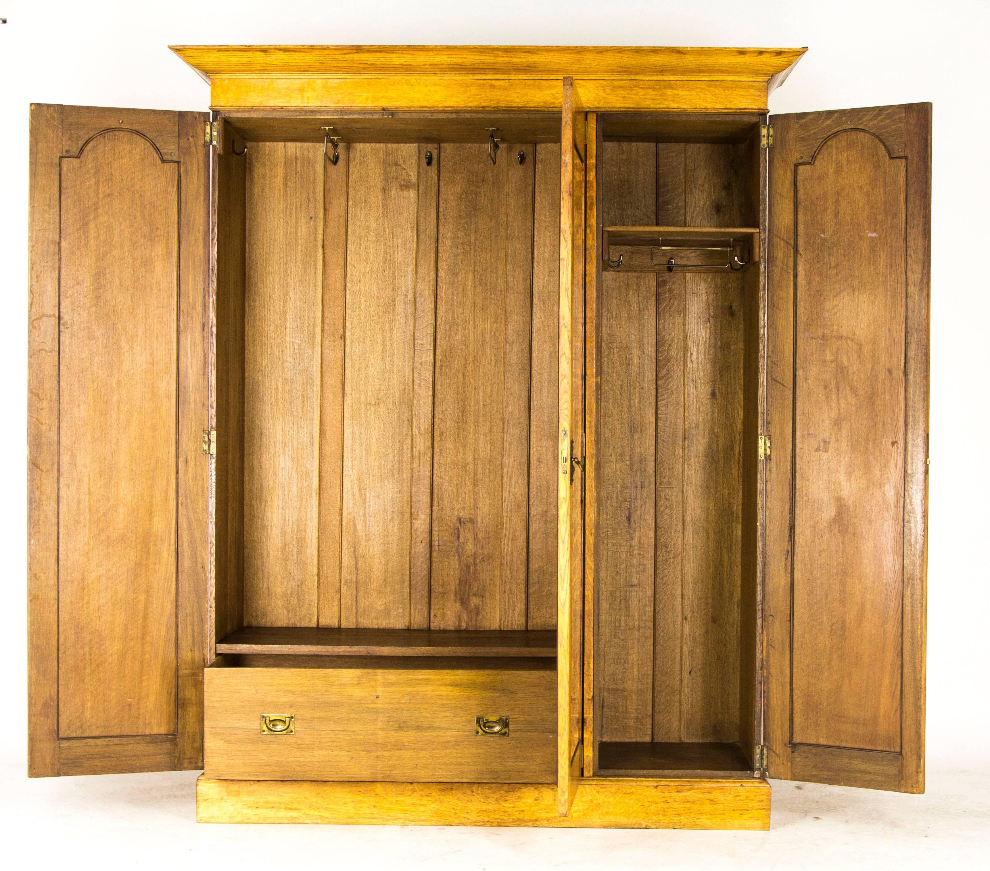 Scotland
1910
Solid oak construction
Probably designed by George Logan for Wylie and Lockhead
Flared cornice above
Central beveled mirror door
Flanked by two shaped doors with stylized floral inlay designs
Arts & Crafts cover plate with shaped