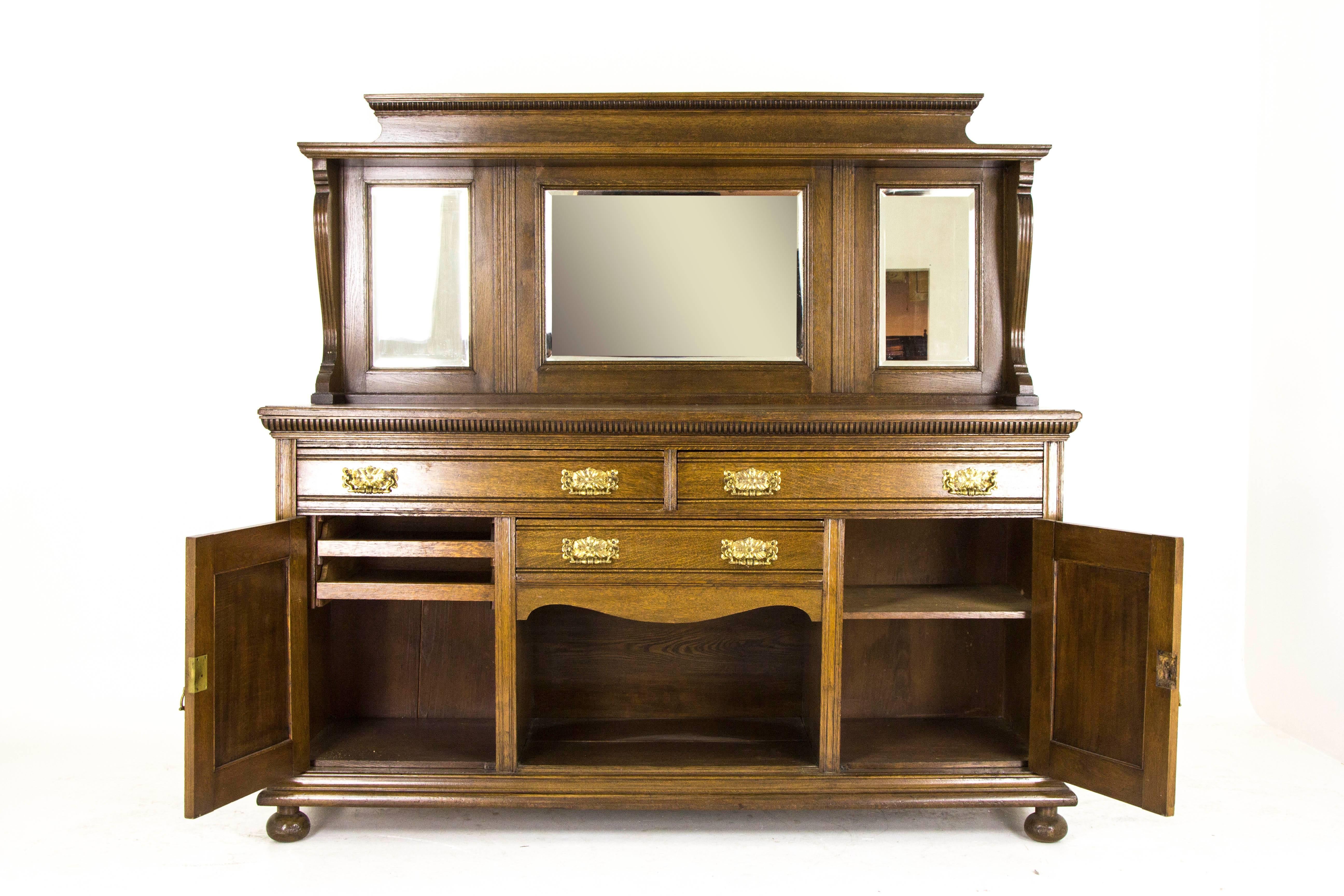 Antique oak sideboard Victorian oak buffet mirror back sideboard 1890 B795

Scotland 1890
Solid oak construction
Original medium oak finish
Carved back with upper shelf
Large beveled mirror flanked by two smaller ones
The base with two large