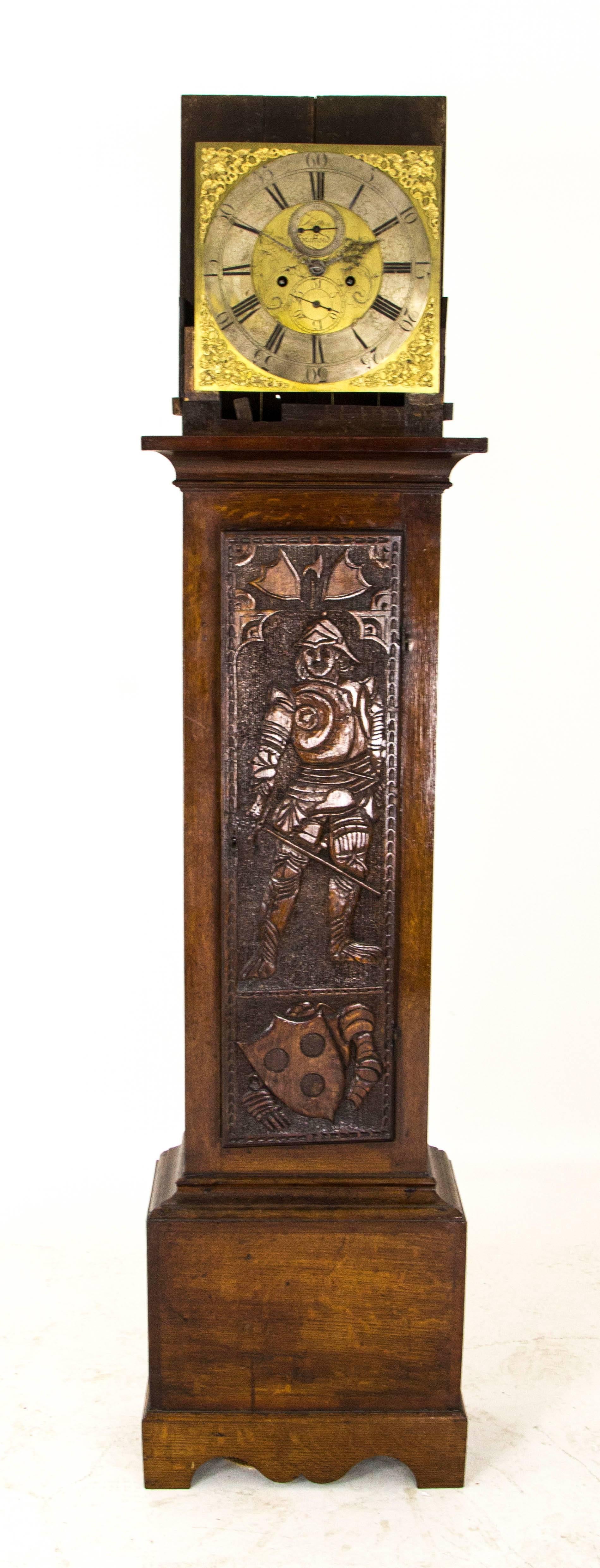 Grandfather clock long case clock brass faced, carved door Sutton of Stratford, B814

England, mid-18th century
Original solid oak case
Turned side pillars
Long front door with an image of a knight face.
Brass dial with corner spandrels
Steel