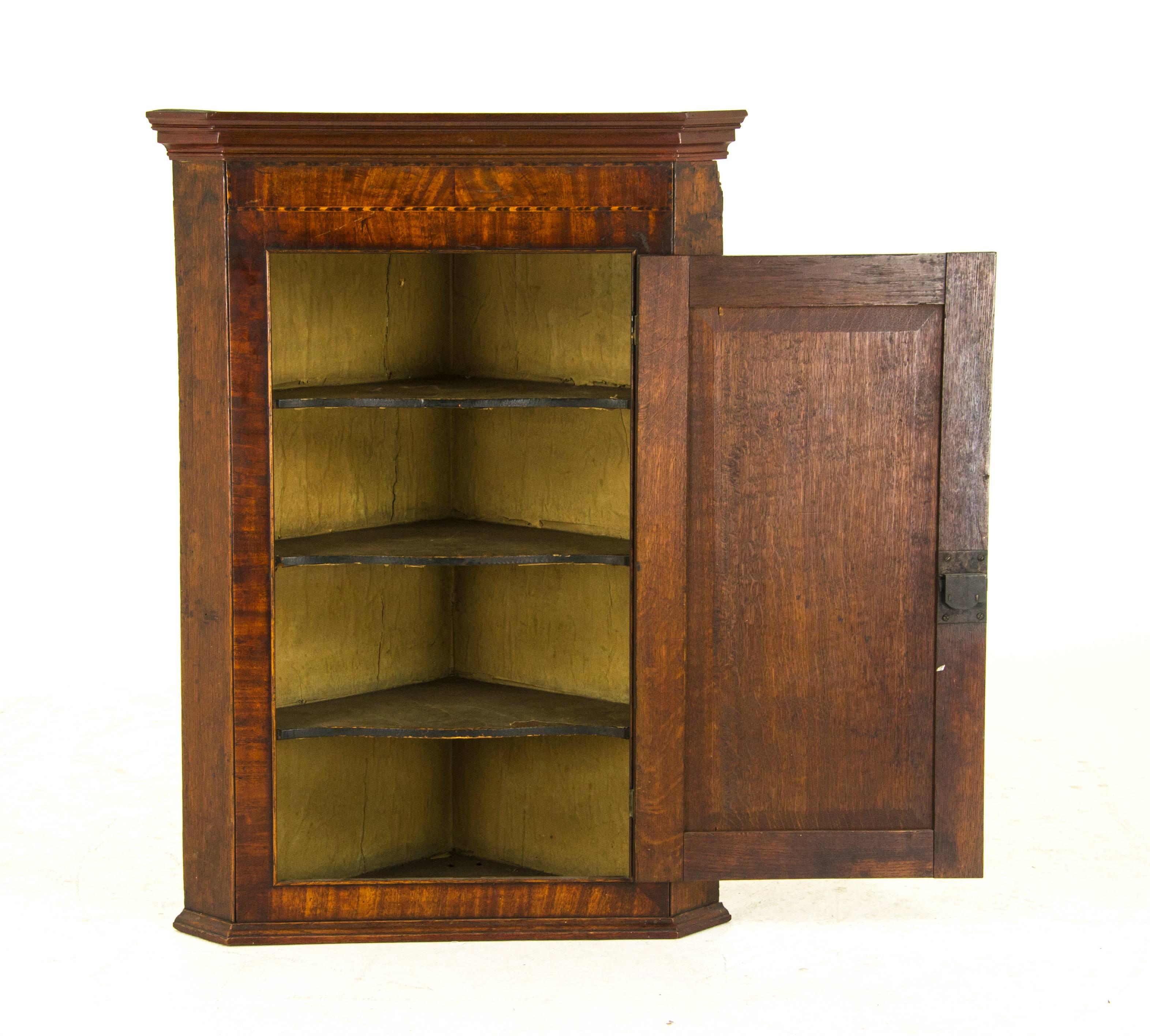 Scotland, 1790
Solid oak construction
Original finish
Moulding above with inlaid banding across the top
Single inlaid panelled door
Opening to reveal triple serpentine original fixed shelves
Ending with crown moulding to base
Lock works and