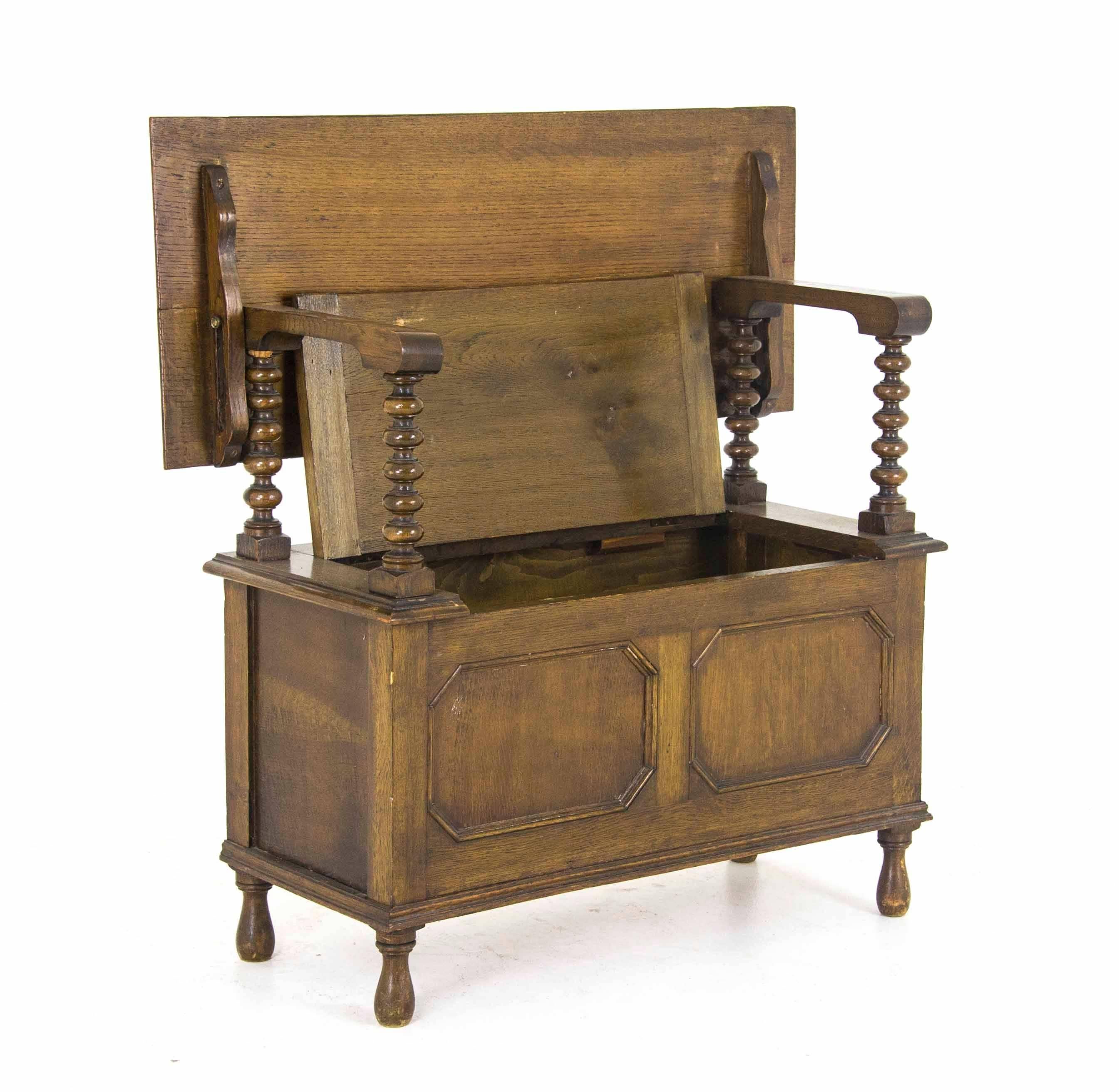 Antique monks bench carved hall bench, Scotland, 1910.

Scotland, 1910
Solid oak construction
Original finish
Carved top, which lifts up and becomes a backrest
Supported by two supports with extending arms
Lift up seat with storage below
Panelled