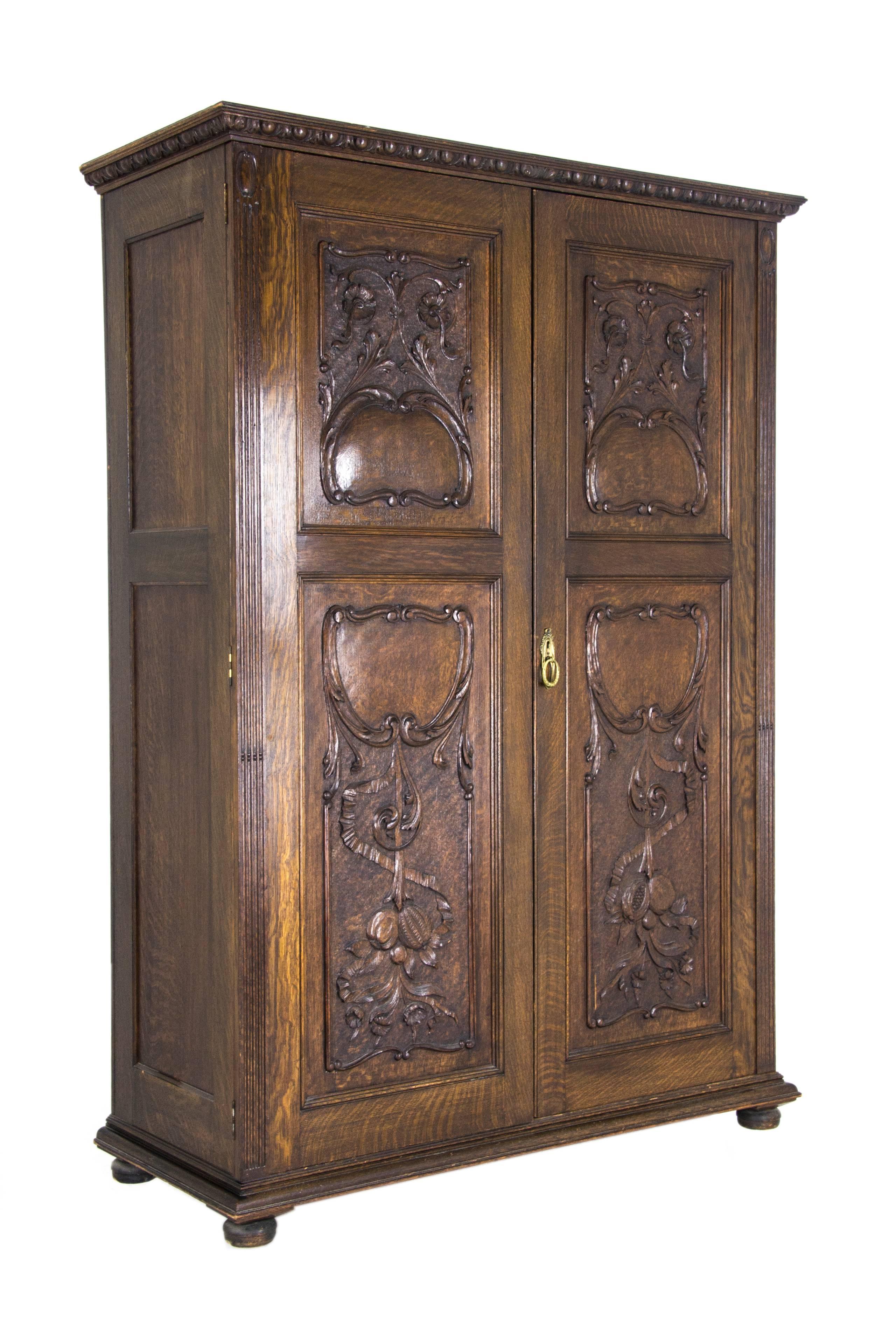 Antique armoire heavily carved tiger oak Scotland, 1890

Scotland, 1890
Solid oak construction
Carved cornice above
Original finish
Two carved raised panelled doors
Two carved panels in each door
Superb deep carving
Lock in working order