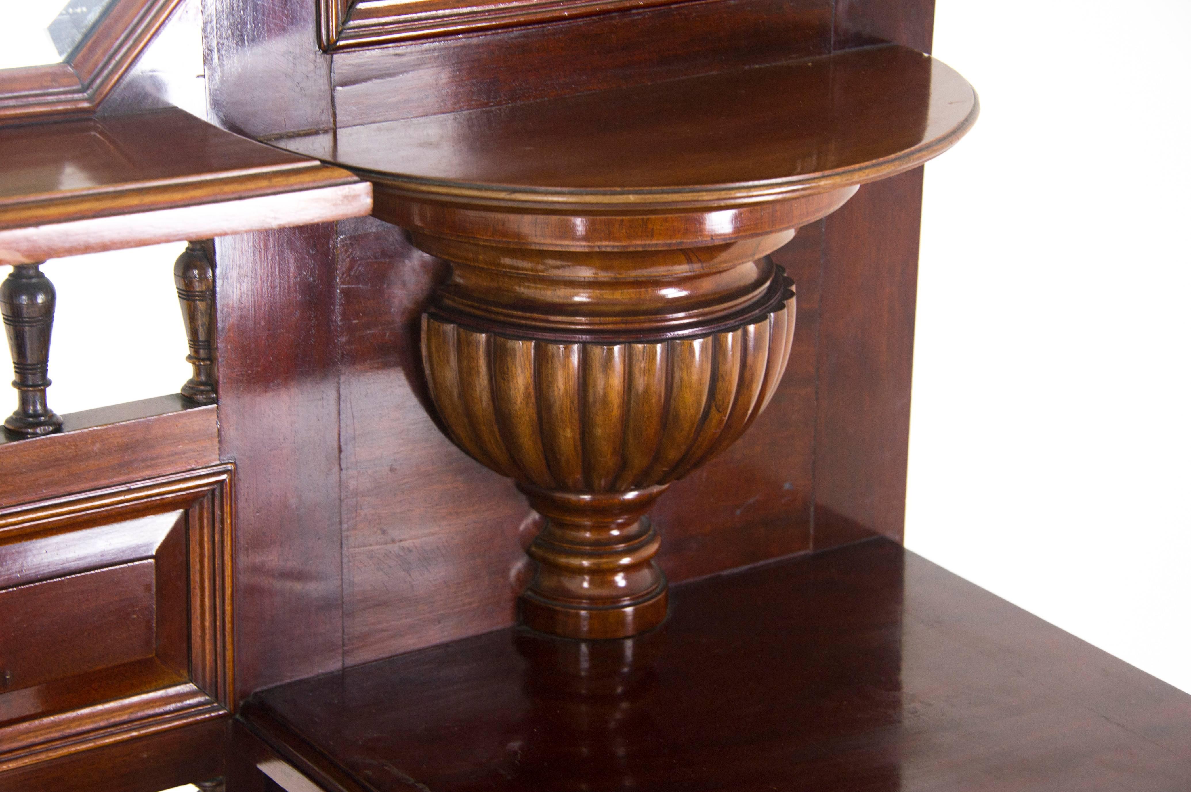 Scotland, 1910
Solid Mahogany
Original Finish
Dentil Cornice Above
Paneled Back with Central Beveled Mirror
Original Art Nouveau Hooks
Two Shelves Below
Central Umbrella Stand, Flanked by Two Drawers
Ending on Turned Legs
Open Shelf with Two