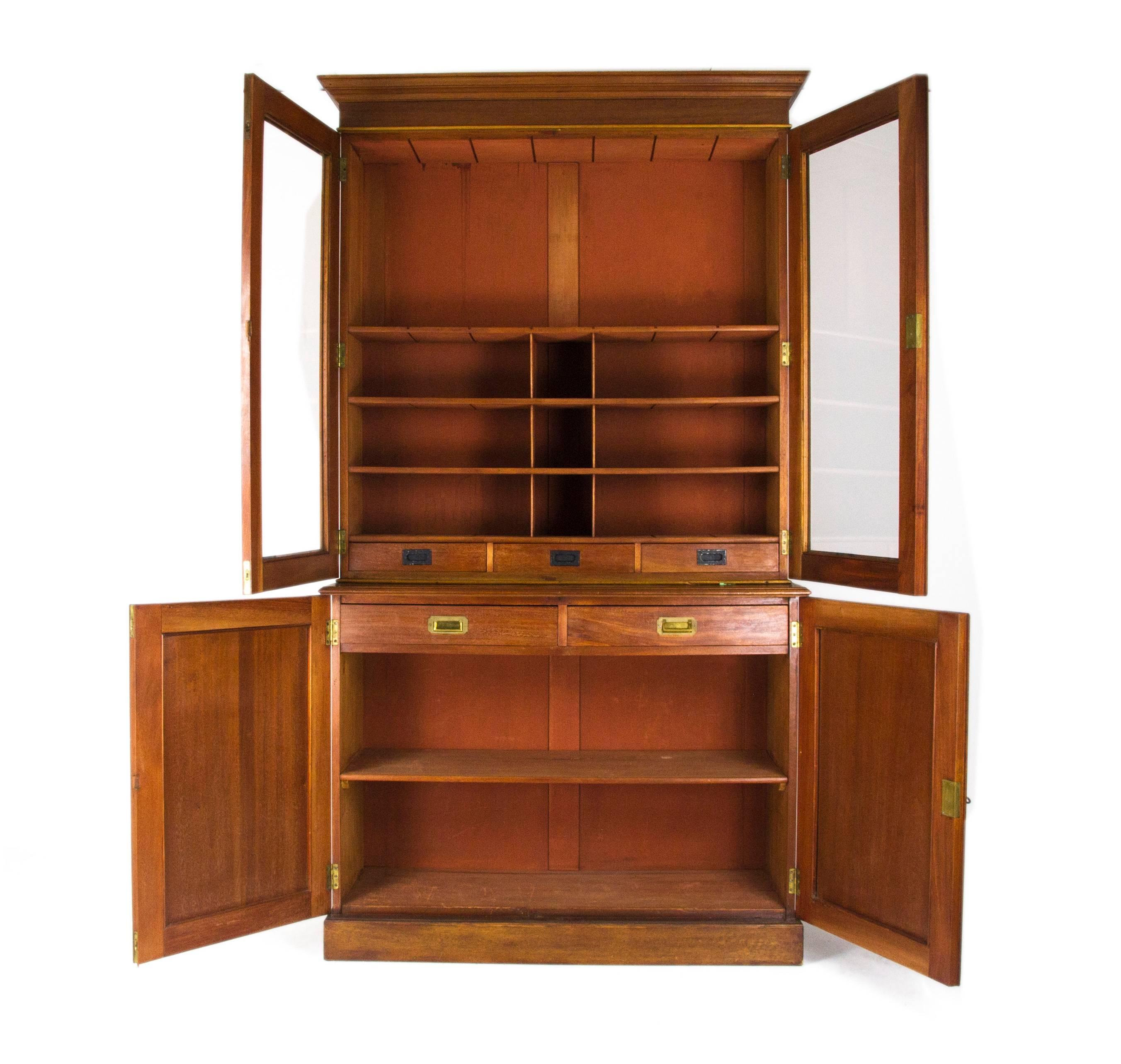 Scotland
1870
Solid Walnut construction
Original finish
Painted interior
Rectangular top
Flared cornice above
Two glass doors below
Three fixed shelves interior
Two doors below with two fitted dovetailed drawers one fixed shelf
Separates into two